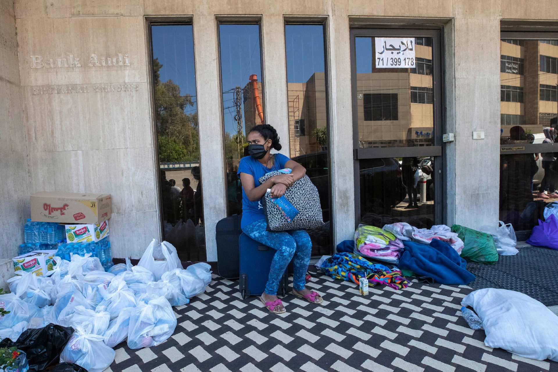 An Ethiopian domestic worker waits in front of the Ethiopian consulate after she and others were abandoned by their Lebanese employers, in Hazmieh, east of Beirut, Lebanon, June 4, 2020.
