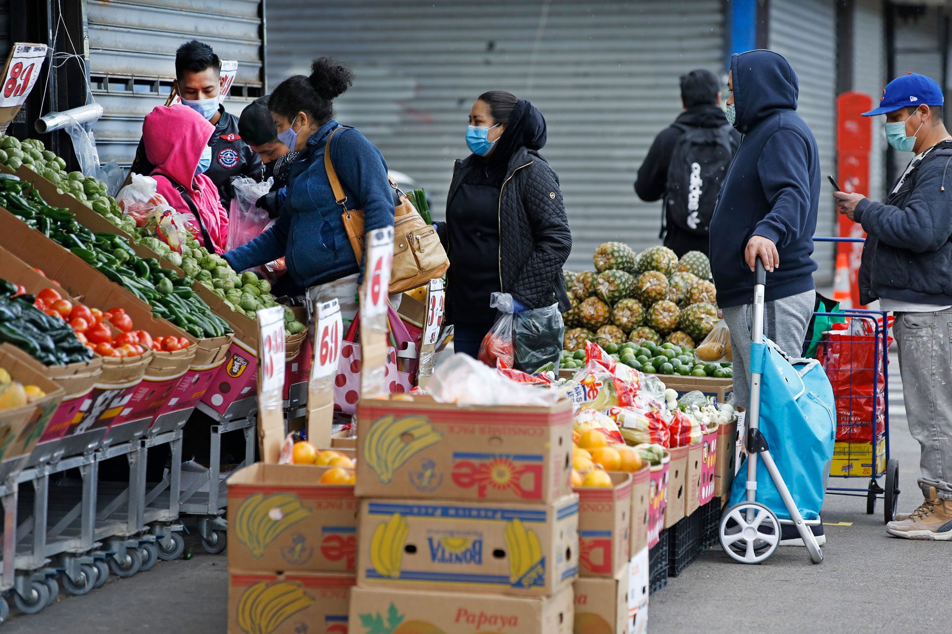 People line up outside a grocery store in the Sunset Park neighborhood of Brooklyn, New York, May 11, 2020.