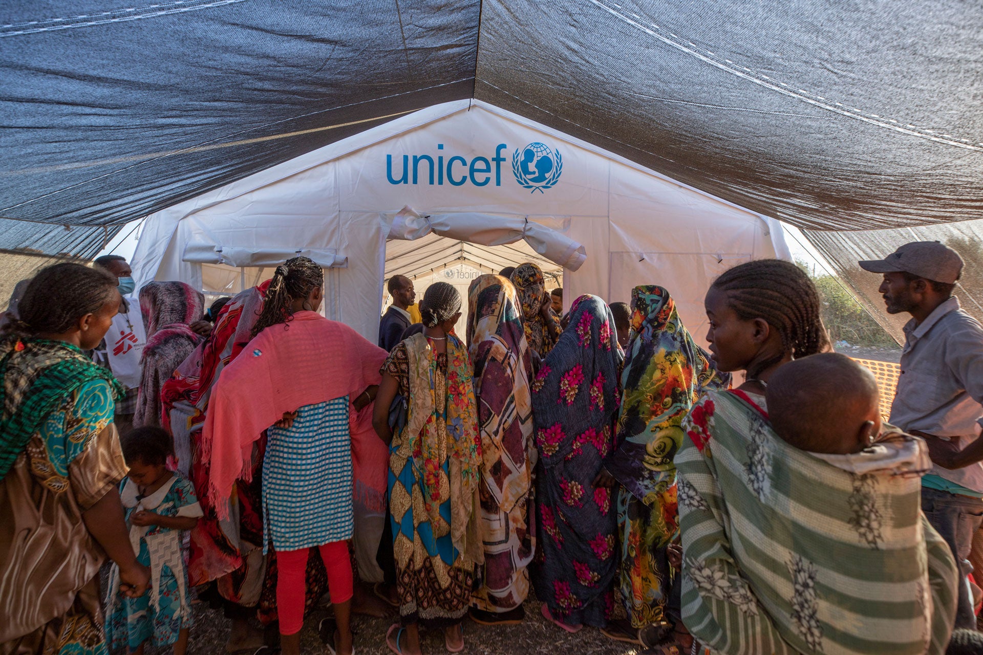 People who fled the conflict in Ethiopia's Tigray region wait to receive treatment at a clinic run by Médecins Sans Frontières (MSF) in Village 8 transit center near the Lugdi border crossing, eastern Sudan, December 8, 2020. 