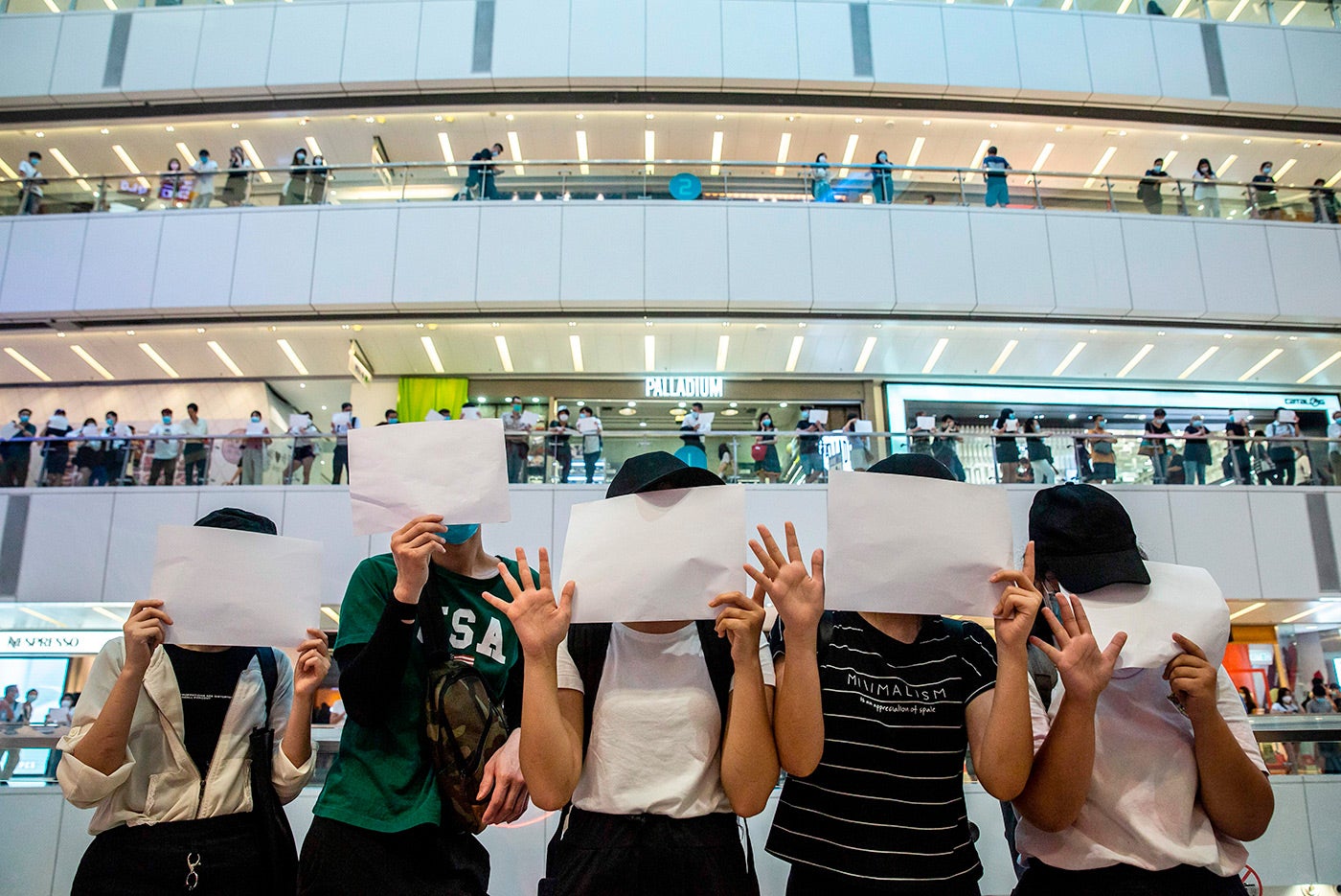 Protesters hold up blank papers during a demonstration in a mall in Hong Kong on July 6, 2020, in response to the Hong Kong government’s ban of the 2019 protest slogan, “Liberate Hong Kong, the Revolution of Our Times.