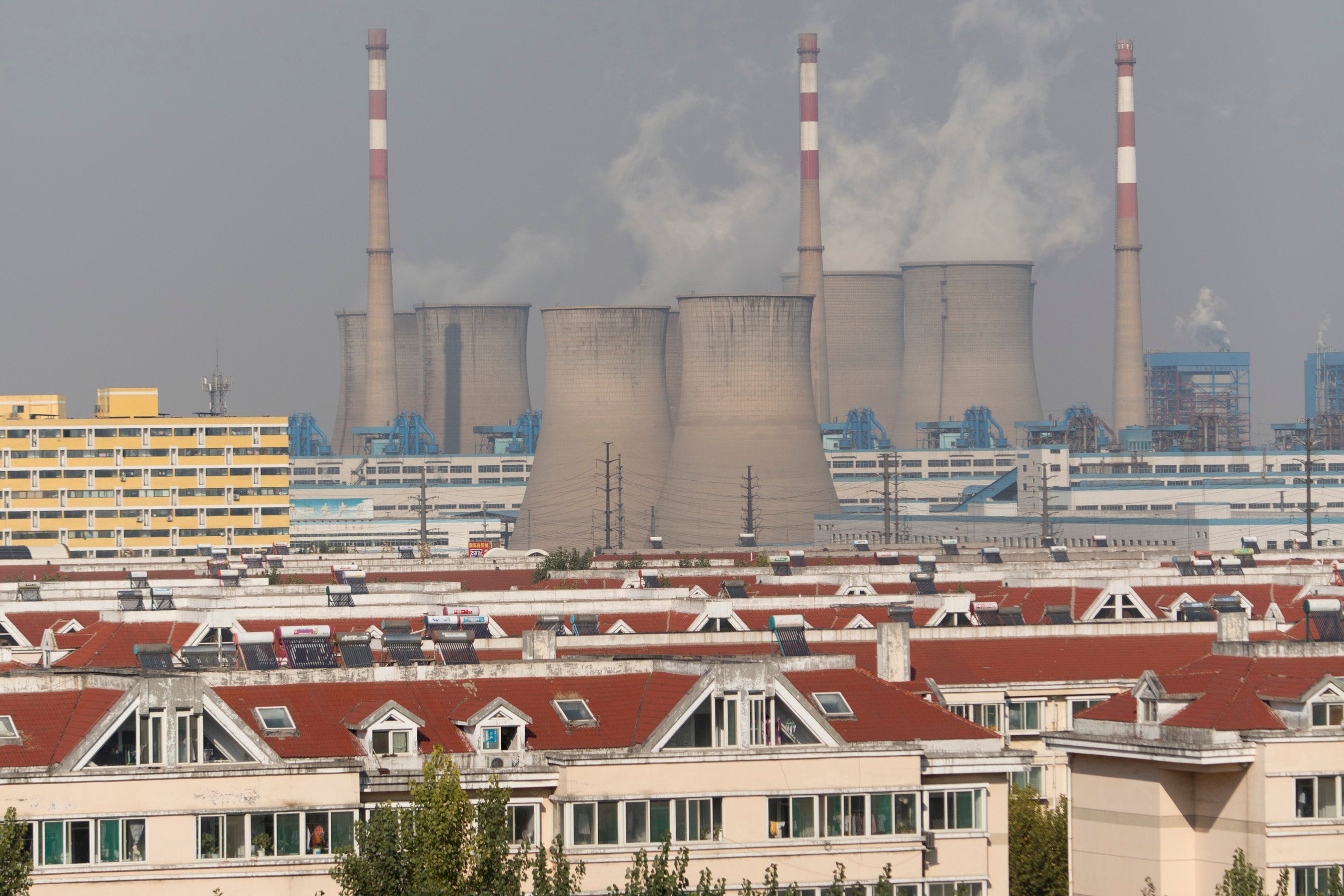 A coal plant looming over a city