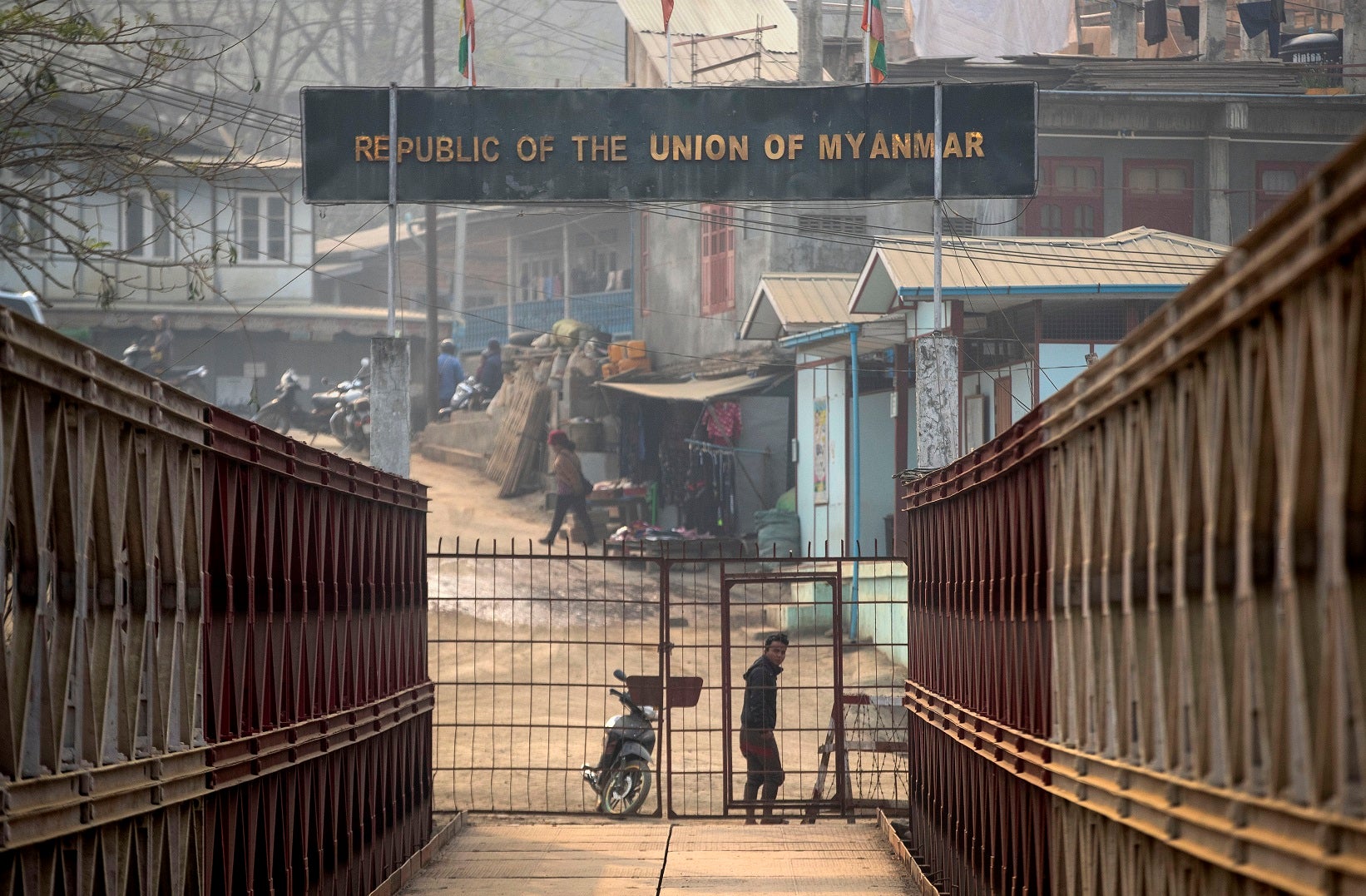 A Myanmarese man looks towards the Indian side at the India-Myanmar border in Mizoram, India, Saturday, March 20, 2021. 