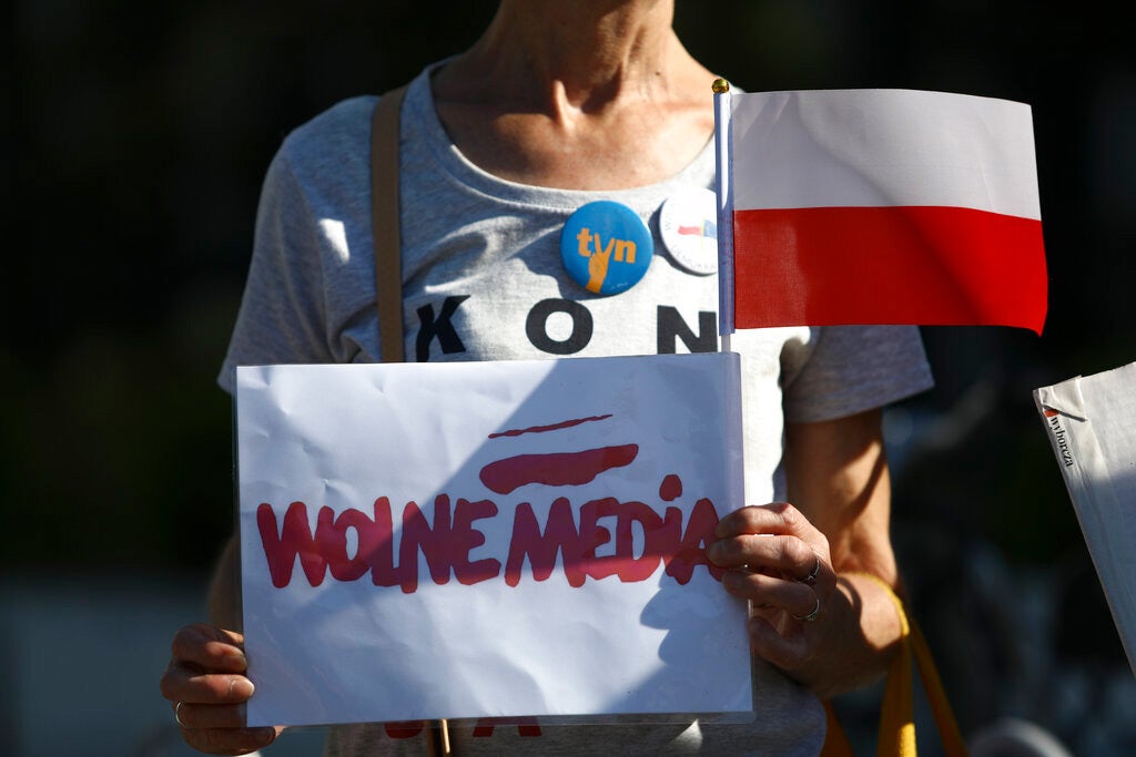 A woman holds a sign with the words "Free media" in Warsaw, Poland on August 11, 2021.