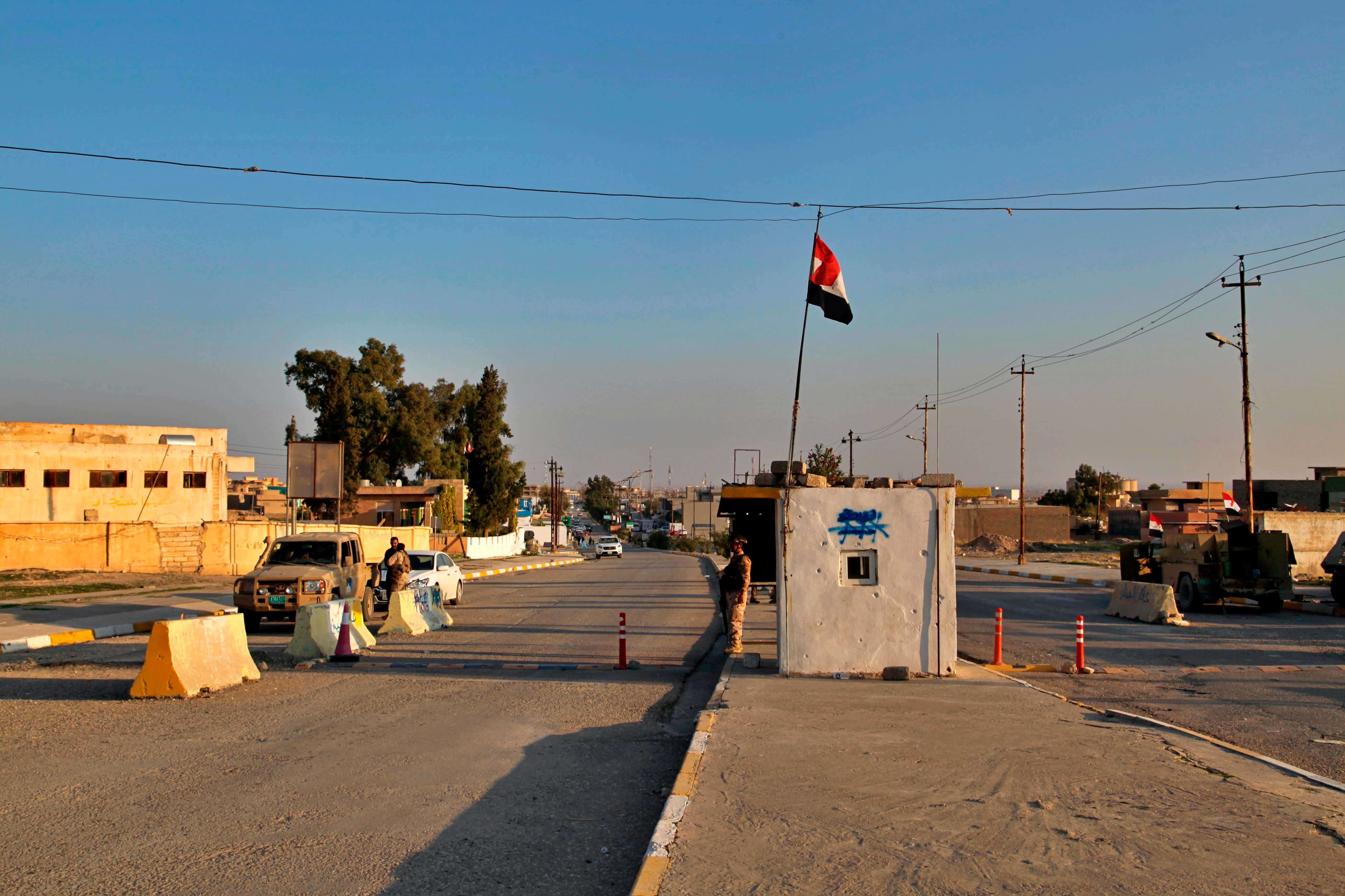 Iraqi soldiers stand guard at a checkpoint in Nineveh, Iraq. Friday Dec. 4, 2020.