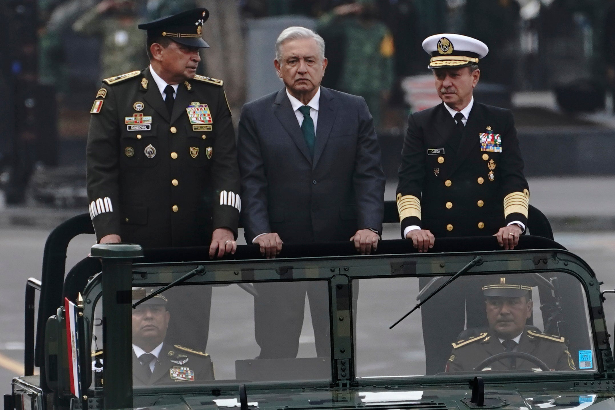 Mexican President Andrés Manuel Lopez Obrador, center, Defense Secretary Luis Crescencio Sandoval, left, and Navy Secretary Vidal Francisco Soberón, right, ride in an open vehicle during the Independence Day military parade in the Zócalo, in Mexico City, on September 16, 2021.