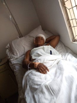 A woman lying on a hospital bed