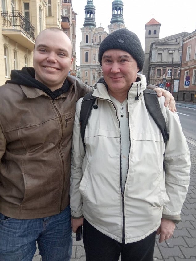 Two men pose for a photo