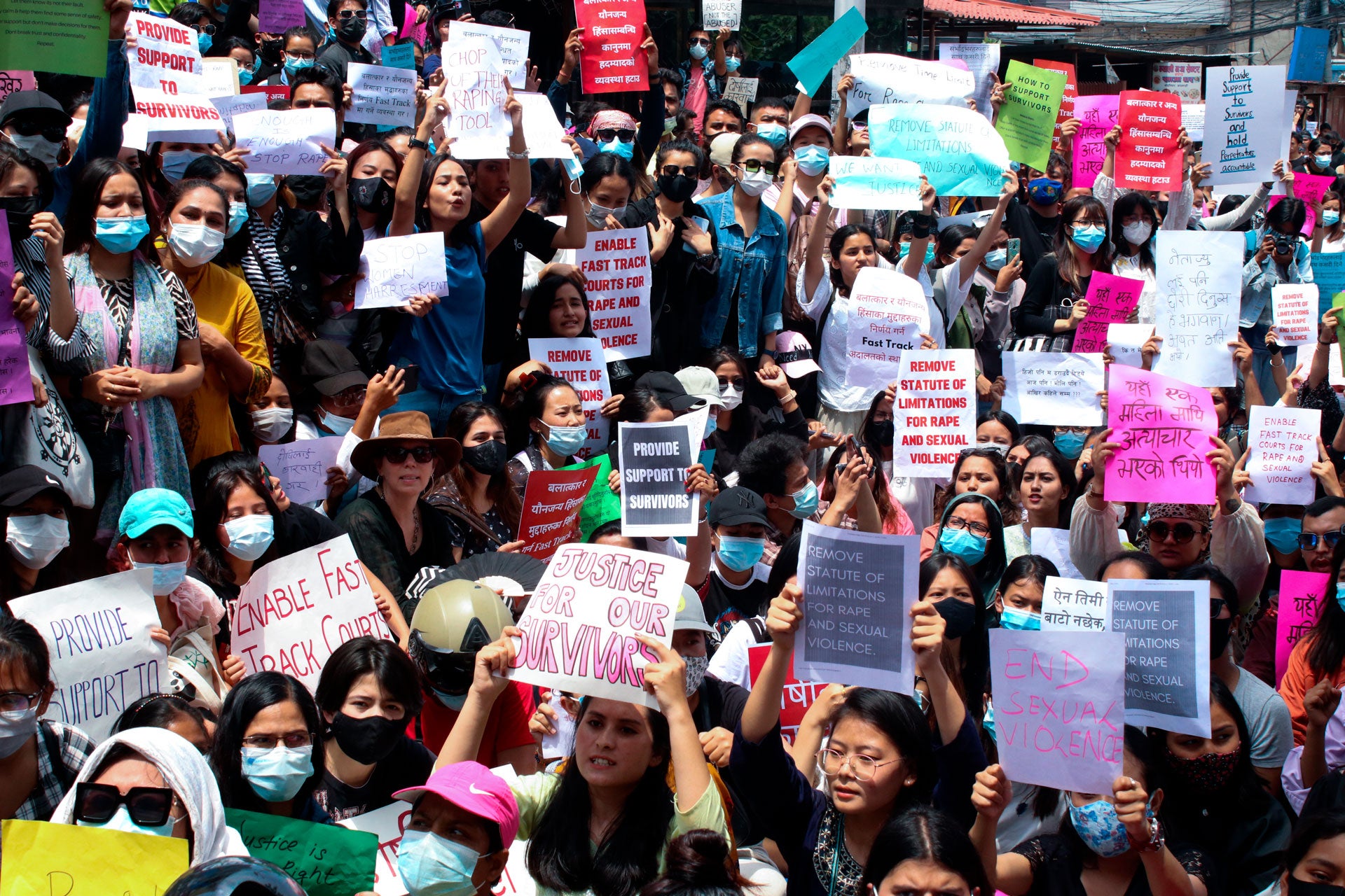 People chant slogans and display placards during a protest