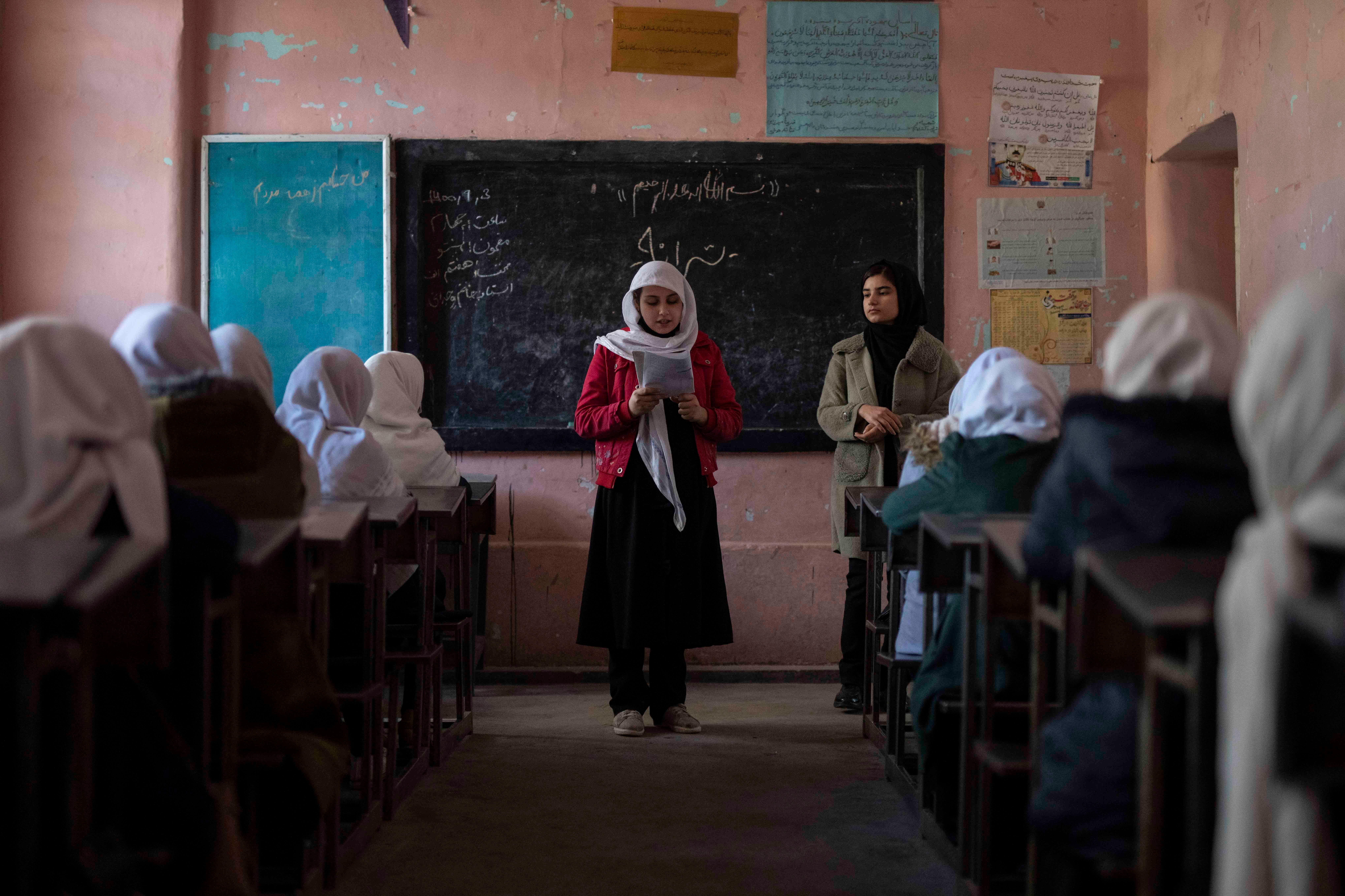 An Afghan girl reads in a classroom at Tajrobawai Girls High School, in Herat, Afghanistan, November 25, 2021.