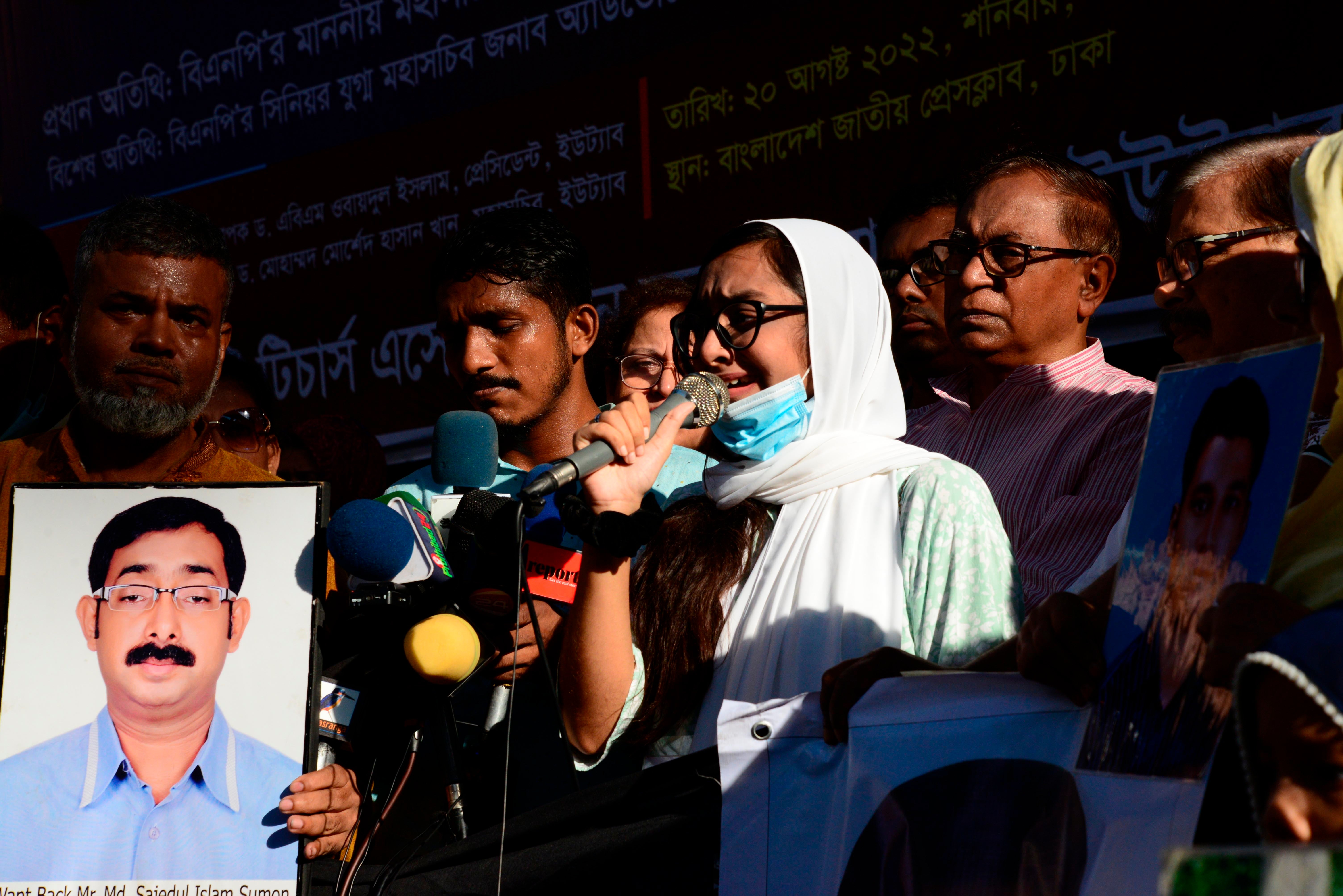 Relatives hold portraits of their missing family members during protest rally on behalf of victims of enforced disappearance by security forces, in front of National Press Club in Dhaka, Bangladesh, August 20, 2022.