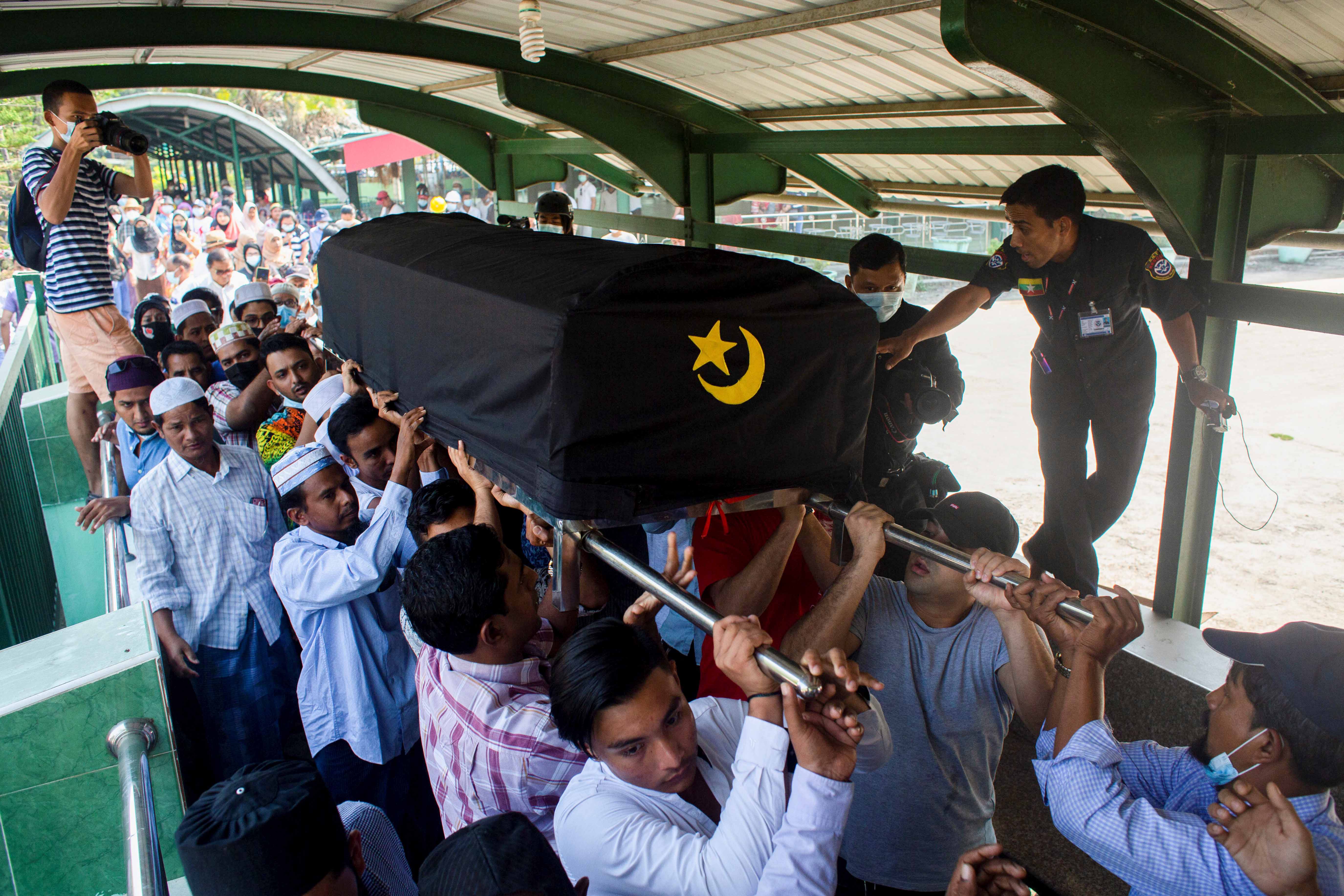 People attend the funeral of Khin Maung Latt