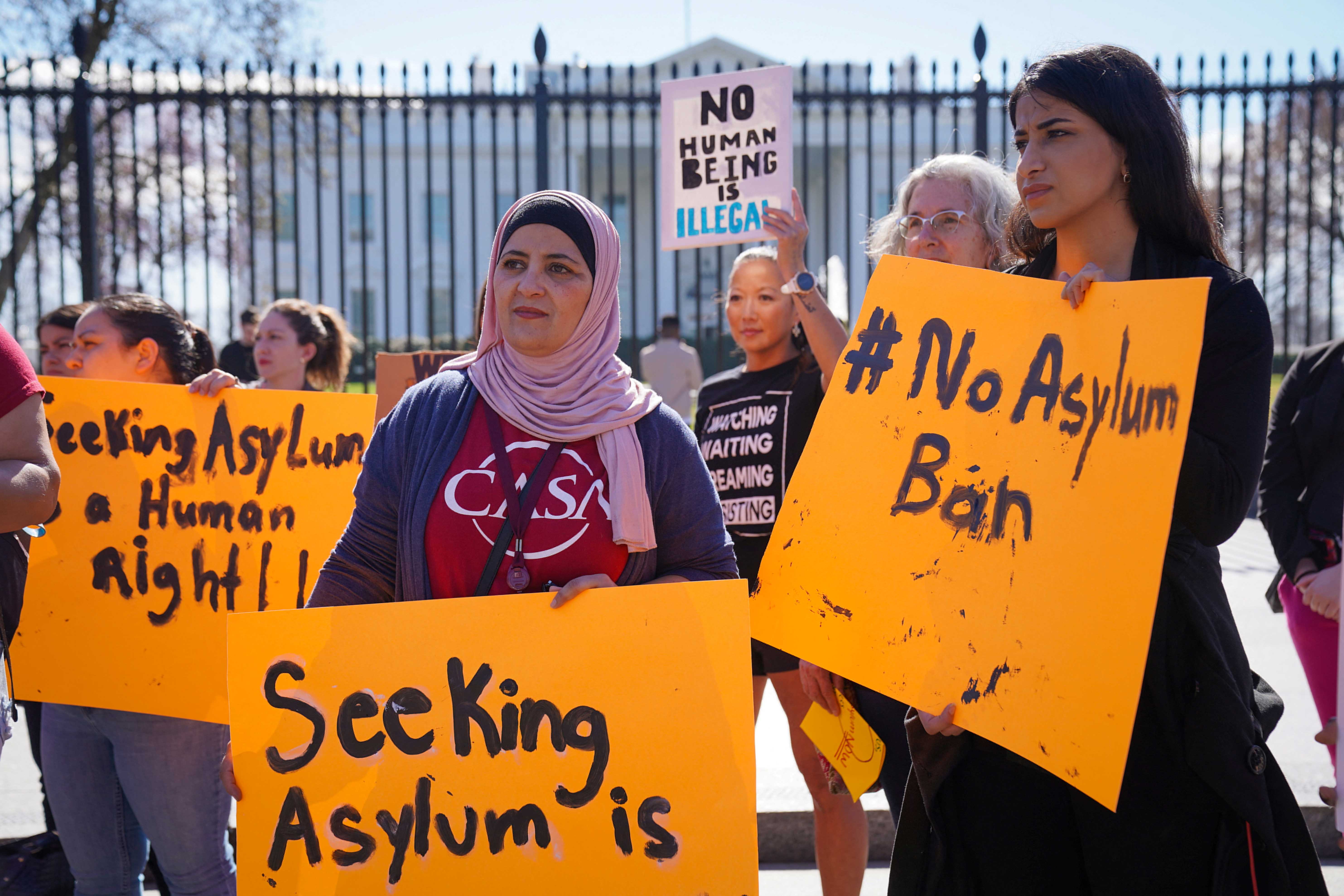 Protesters with the #WelcomeWithDignity campaign and Interfaith Immigration Coalition hold signs in opposition to Biden administration's asylum ban, outside of the White House in Washington, DC, February 23, 2023. 