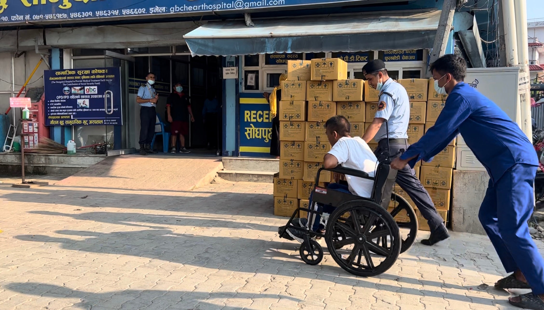 Man Bahadur has breathing problems while en route to the hospital so he is rushed inside in a wheelchair, Butwal, Nepal, July 21, 2023.