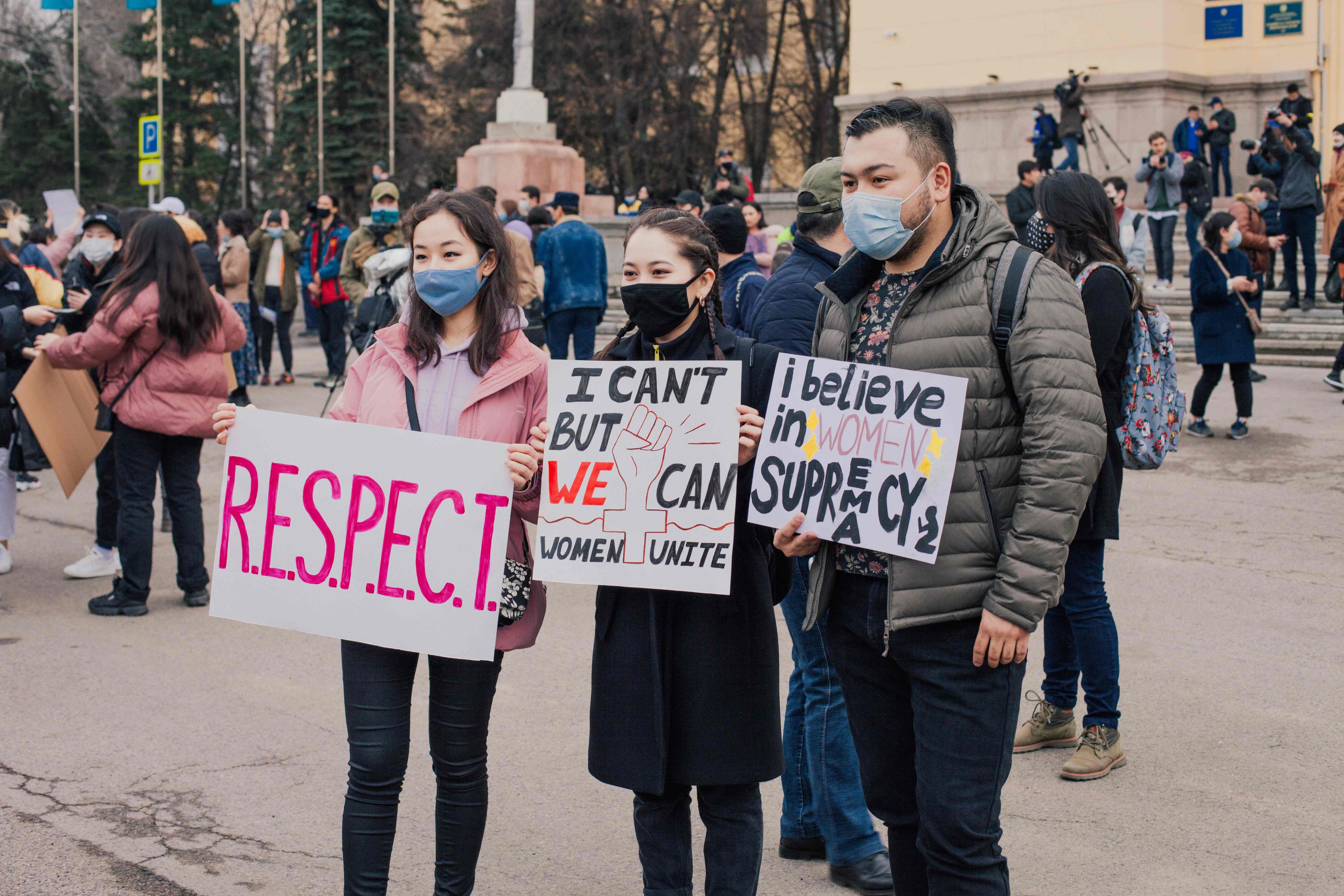 Protesters hold placards 