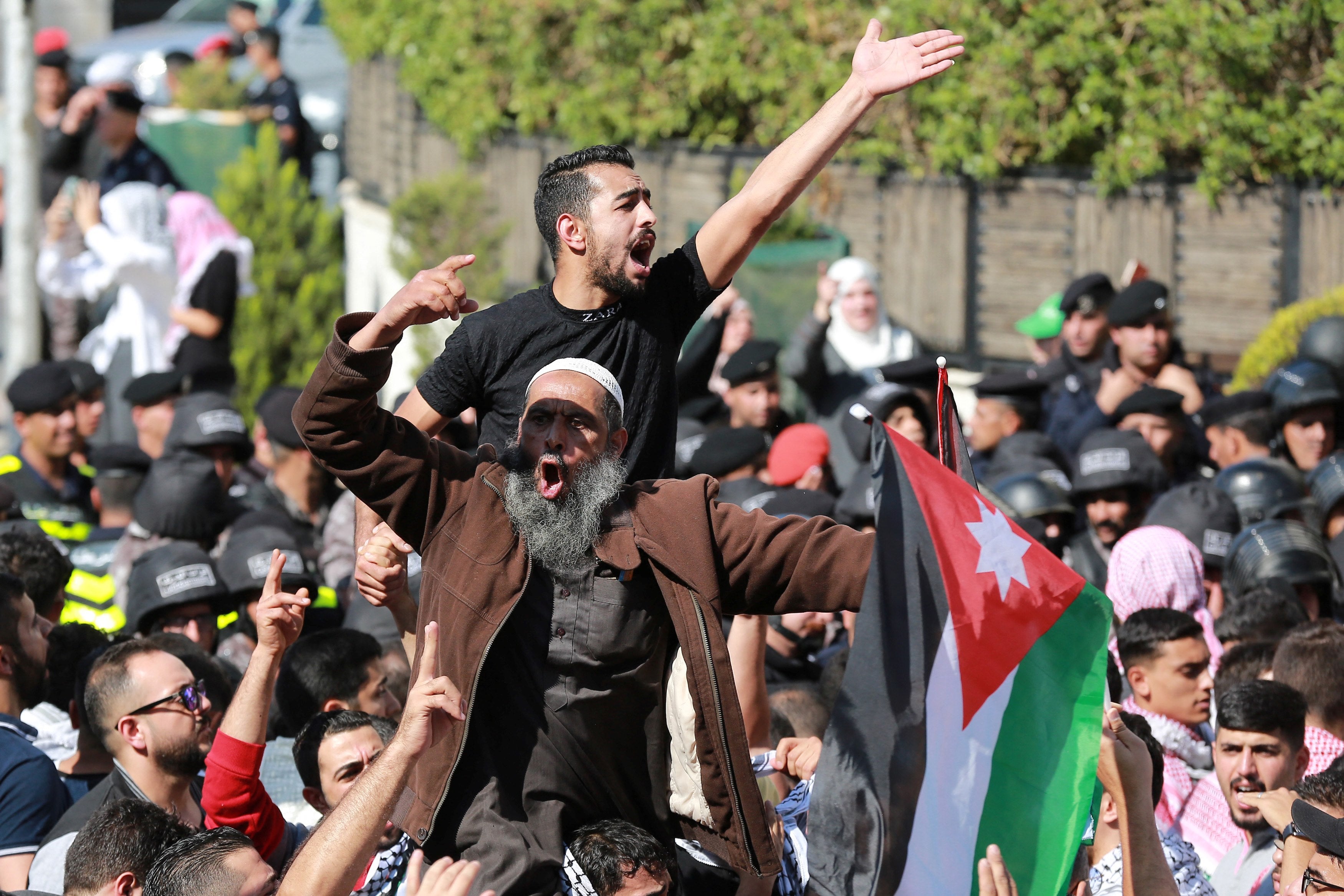 People protest near the Israeli Embassy in Amman on October 18, 2023, as they demonstrate against the killing of hundreds of Palestinians following a strike on a hospital in the Gaza Strip.