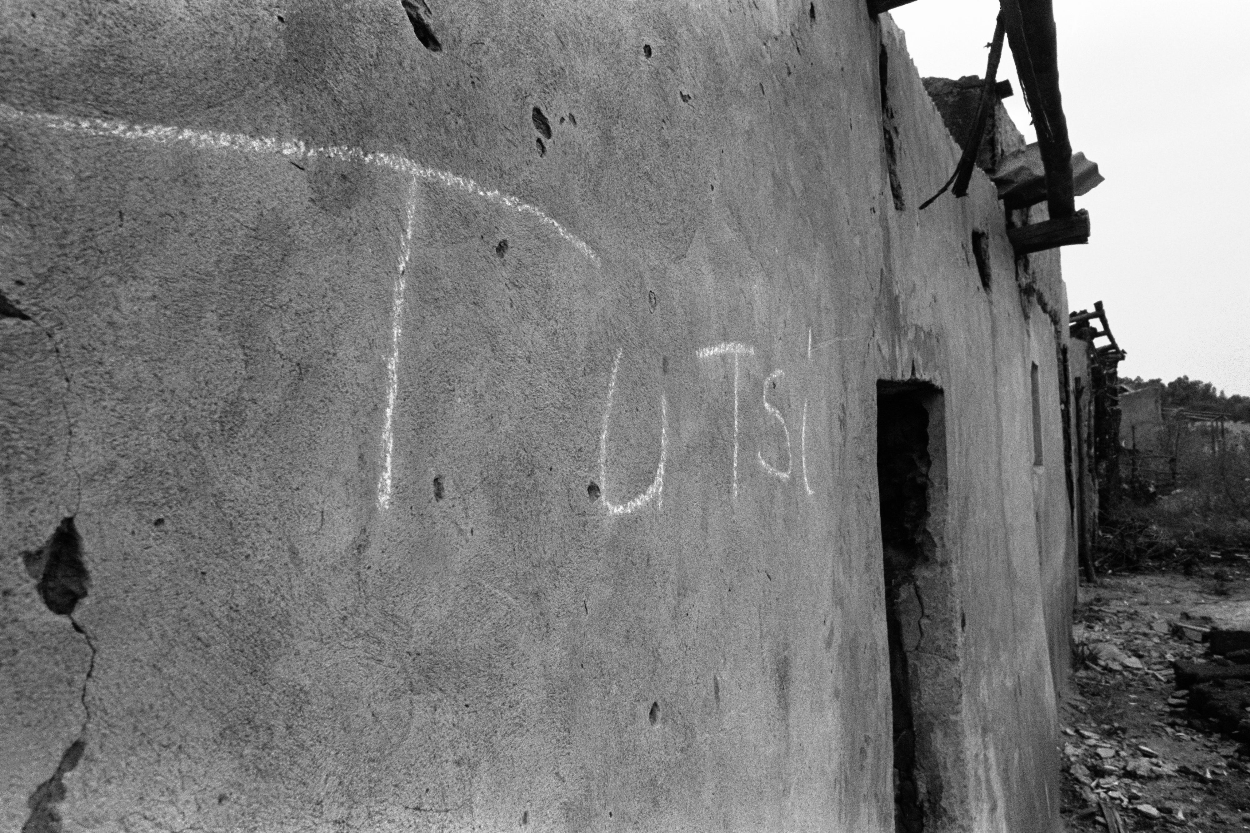 One of many houses marked with the word "Tutsi" stands in a deserted village in eastern Rwanda, just a few kilometers from a church at Nyarubuye in which more than 1,000 people were massacred by Hutu militiamen.