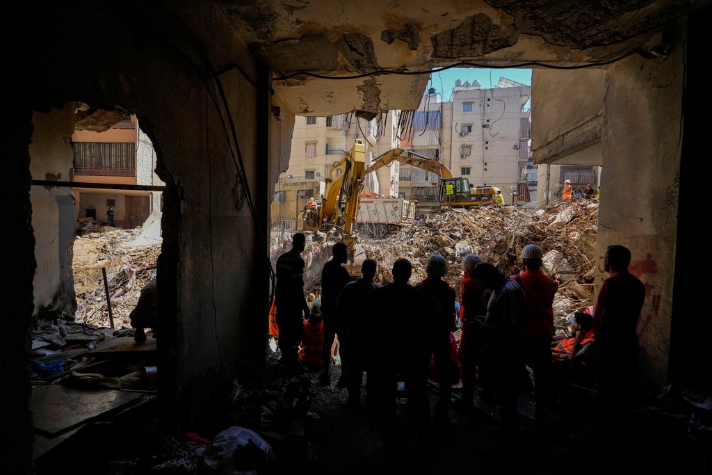 Emergency workers use excavators to clear the rubble at the site of an Israeli strike in Beirut’s southern suburbs, Lebanon, September 23, 2024