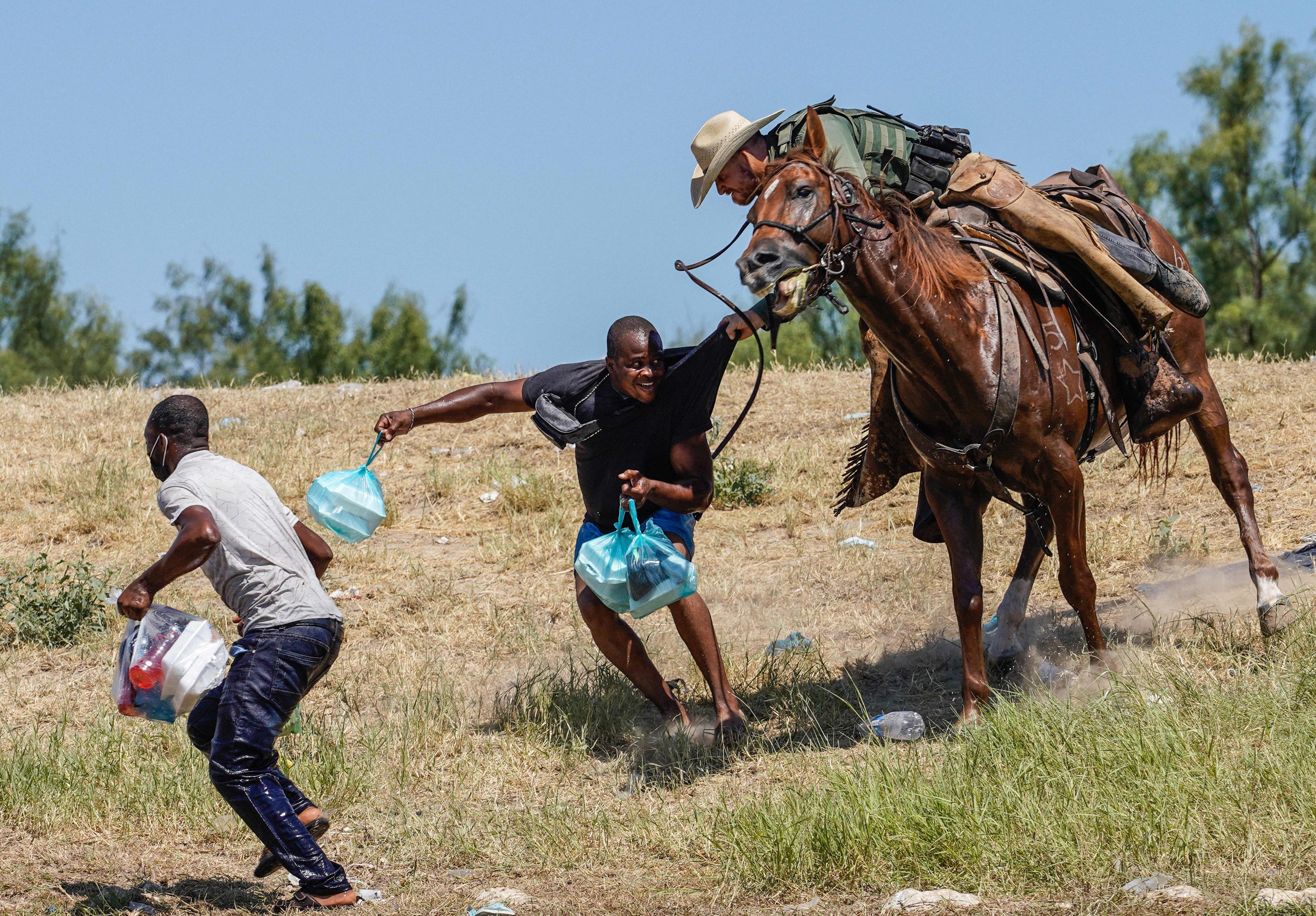 United States Border Patrol agent on horseback tries to stop Haitian migrants from entering an encampment on the banks of the Rio Grande near the Acuña Del Rio International Bridge in Del Rio, Texas on September 19, 2021.