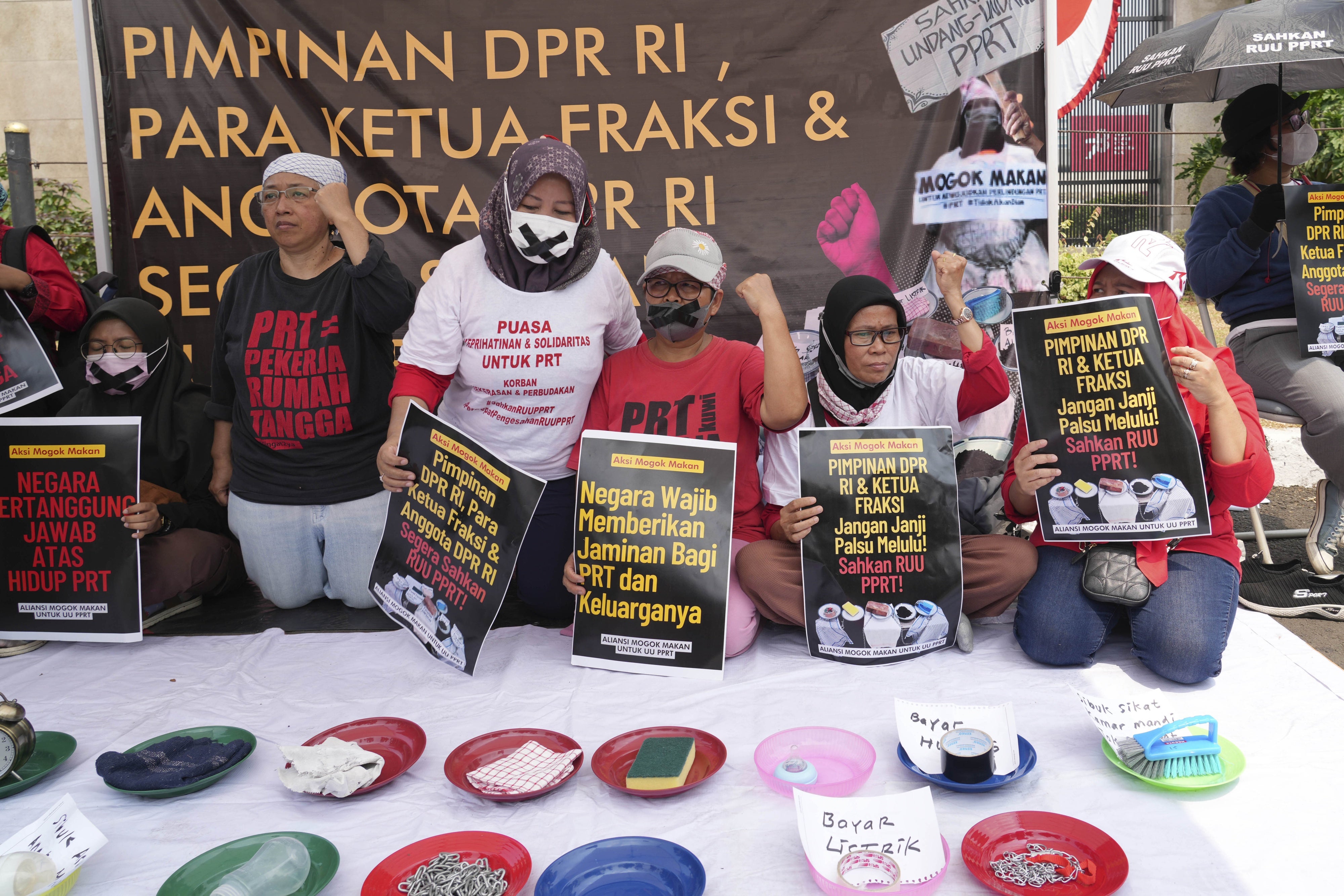 Activists during a protest and hunger strike demanding that parliament to pass a bill to protect domestic workers, at the parliament in Jakarta, Indonesia, August 14, 2023.