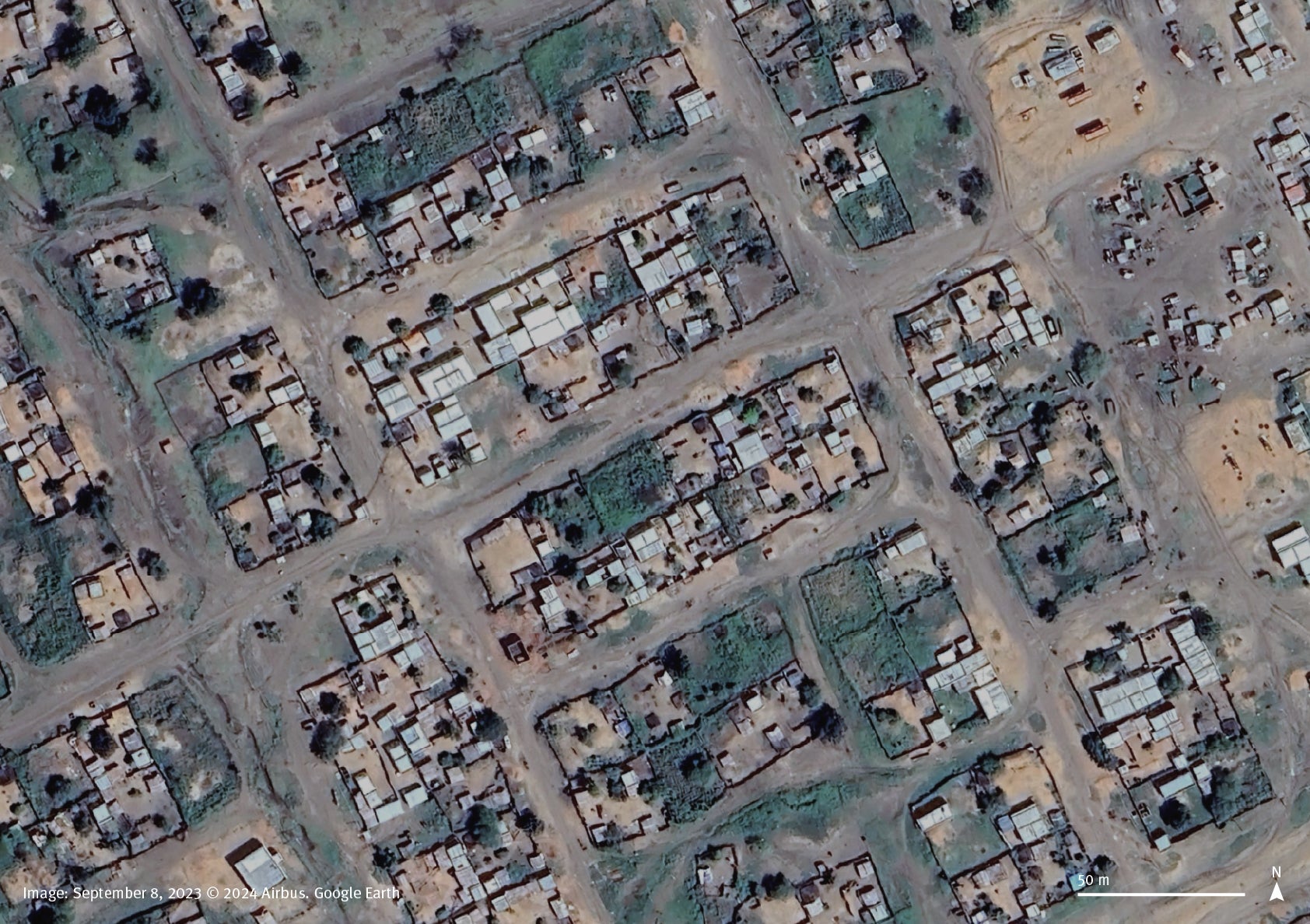 Satellite imagery comparison between September 8, 2023, and November 12, 2024, shows corrugated metal rooftops are missing from the buildings in a residential area in the town of Habila, South Kordofan, Sudan. 