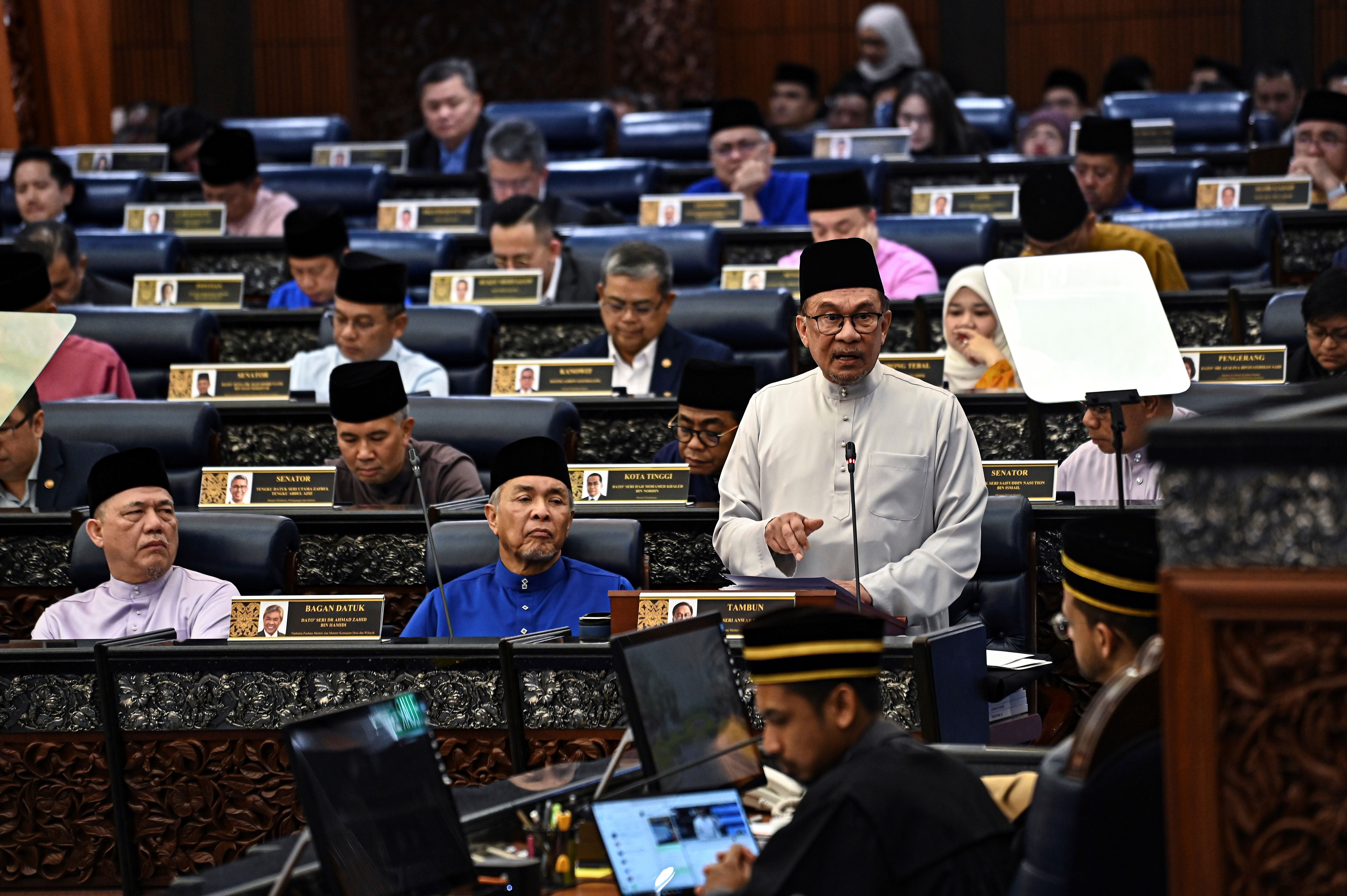 Malaysia’s Prime Minister and Finance Minister Anwar Ibrahim delivers the 2025 budget speech at parliament