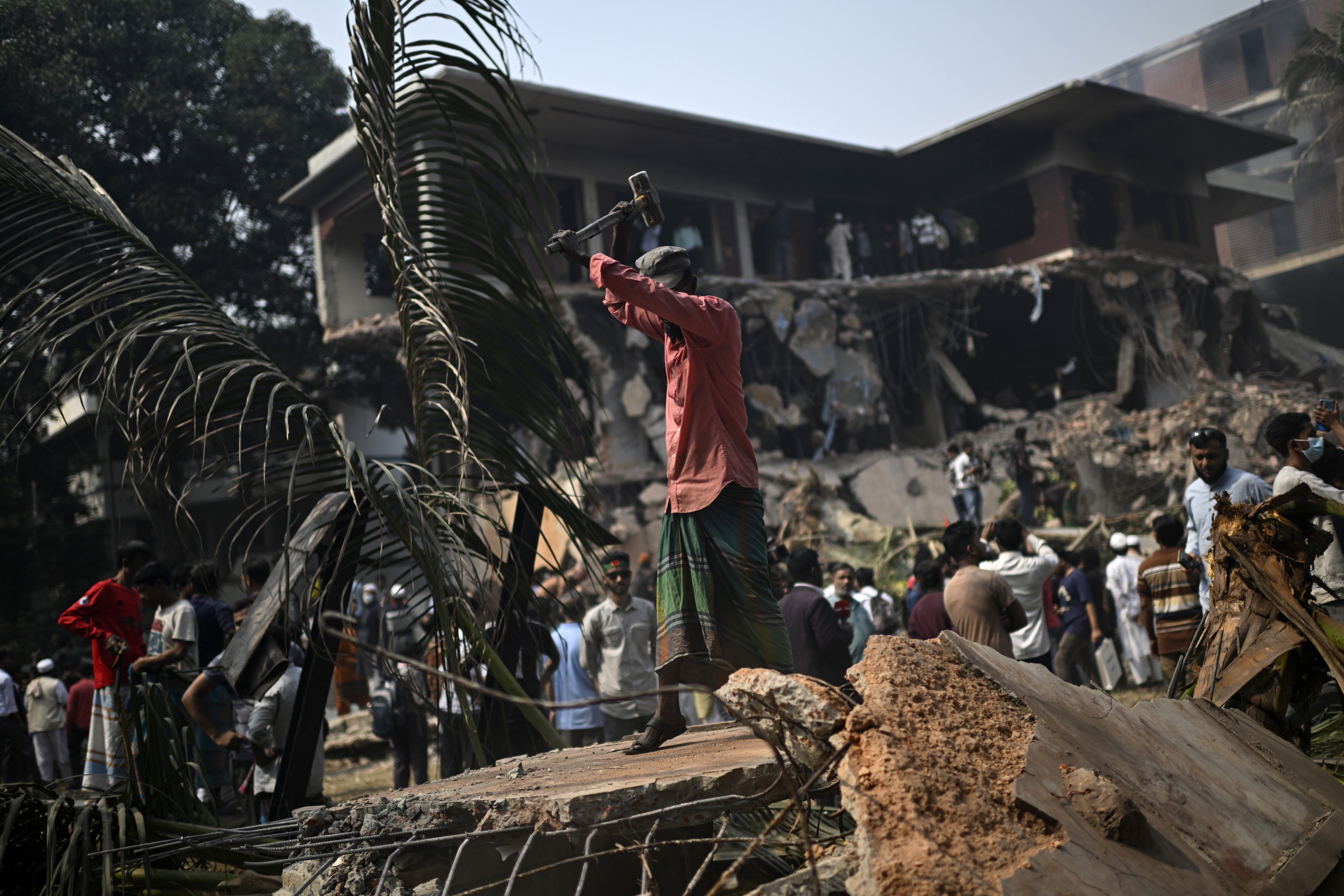 A man hammers the debris around the vandalized residence of Sheikh Mujibur Rahman, Bangladesh's former leader and the father of the country's ousted Prime Minister Sheikh Hasina, in Dhaka, Bangladesh, February 6, 2025.