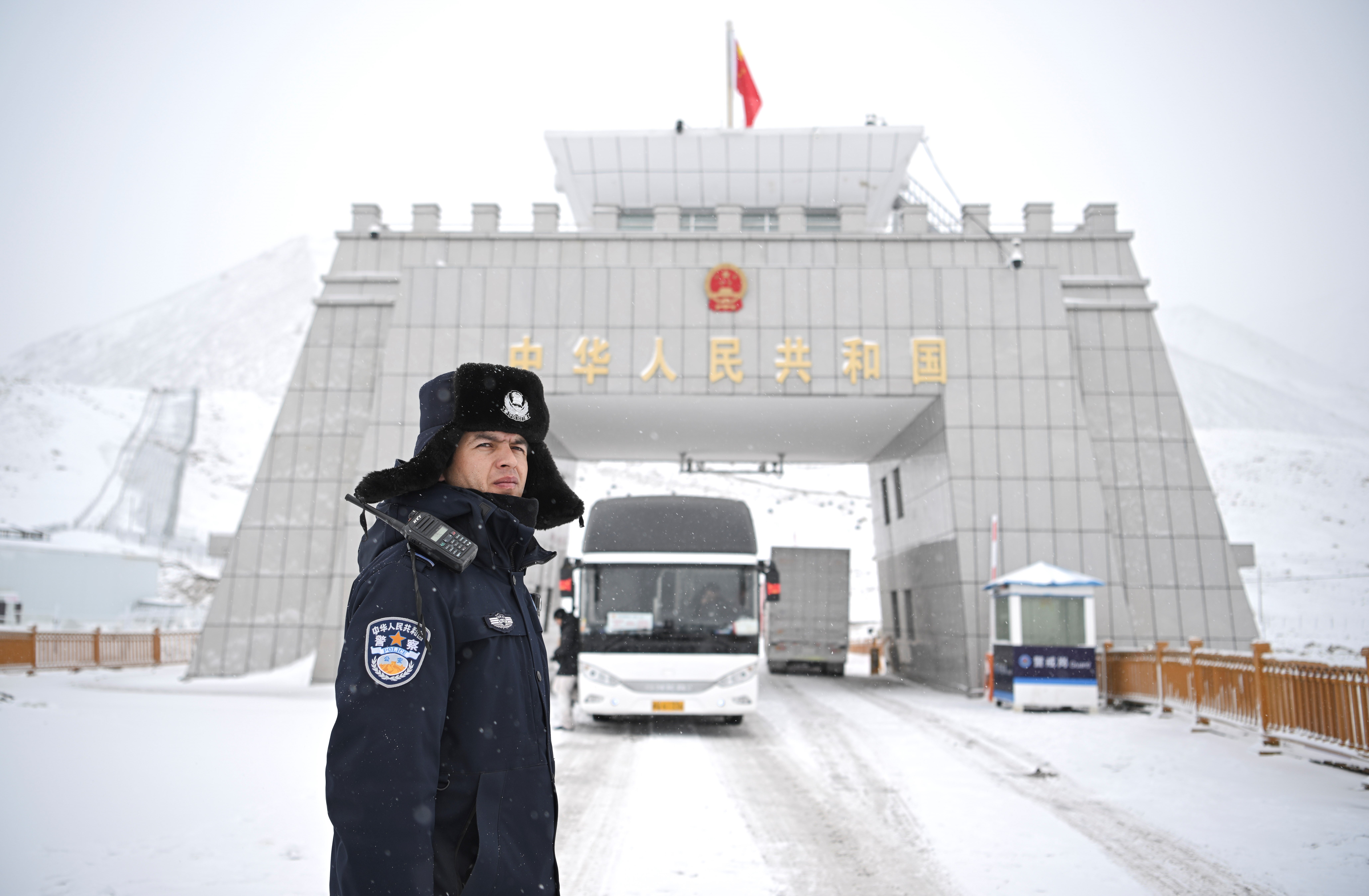 A Chinese police officer on a snowy road.