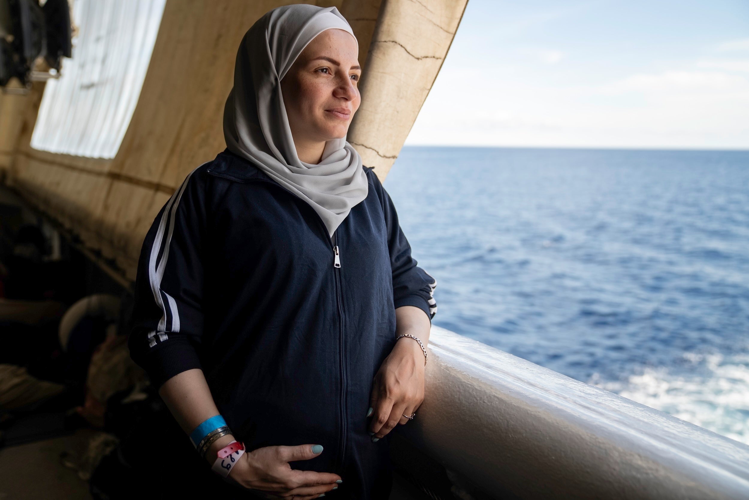A Syrian woman, seven-month's pregnant, looks out at the Mediterranean Sea from the stern of the Geo Barents, September 20, 2024. 