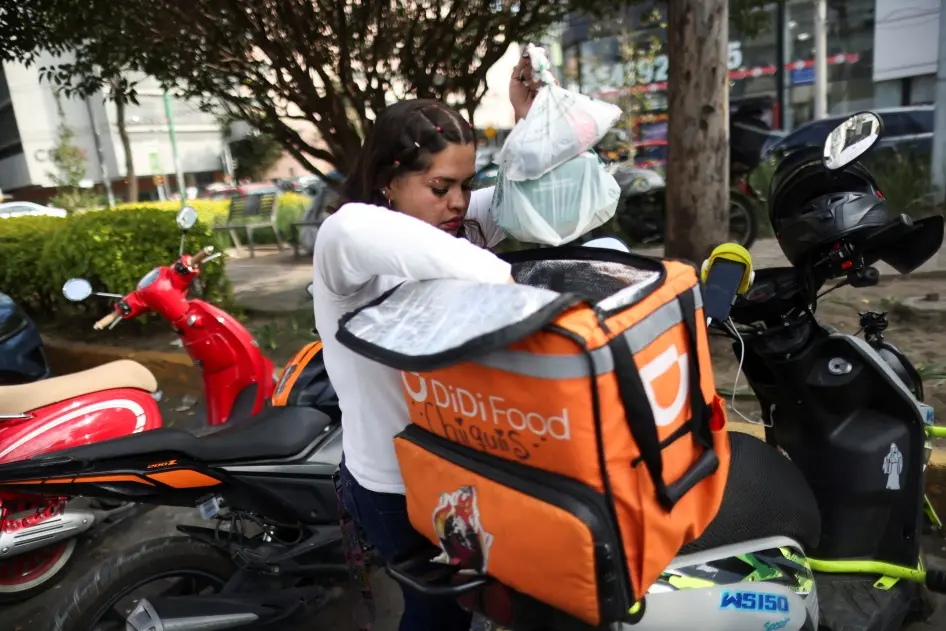 A delivery driver for Didi Food, getting ready to deliver orders, in Mexico City, Mexico, on October 16, 2024, could be one of many workers to benefit from labor reform for workers for digital labor platforms.