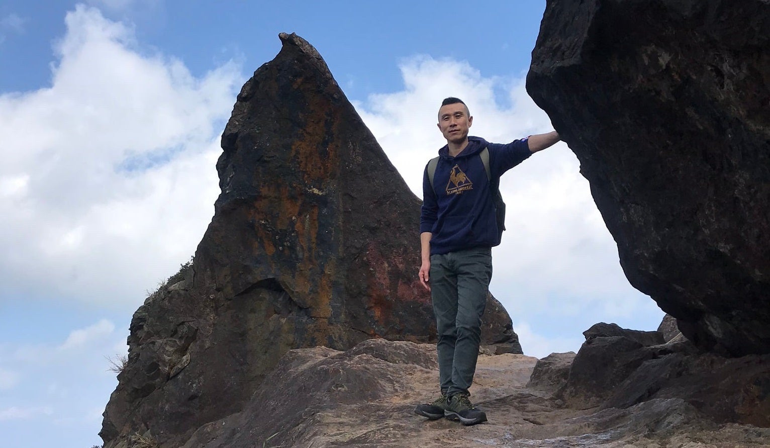 Fu Cha stands on the mountainside