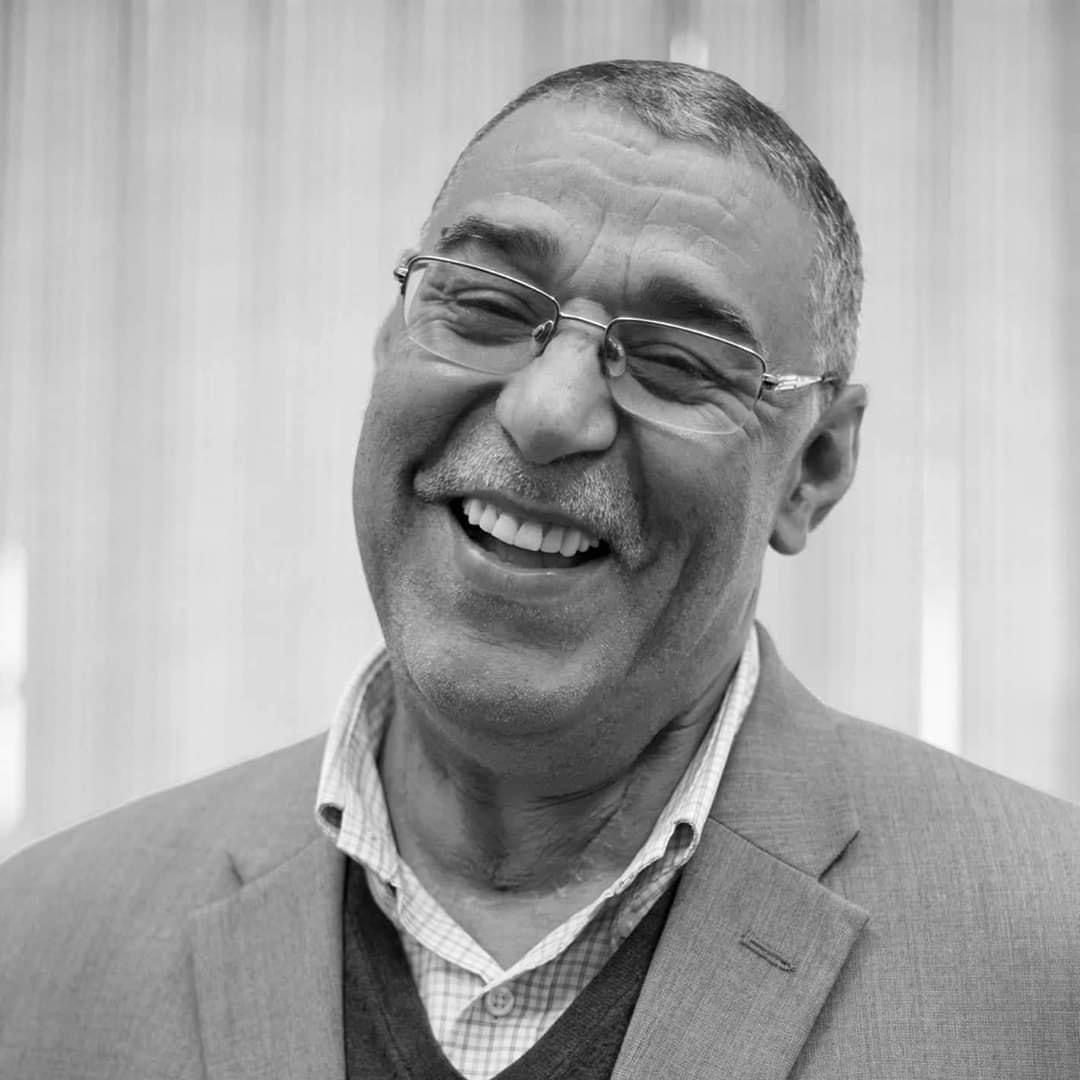 black and white photo of a smiling man