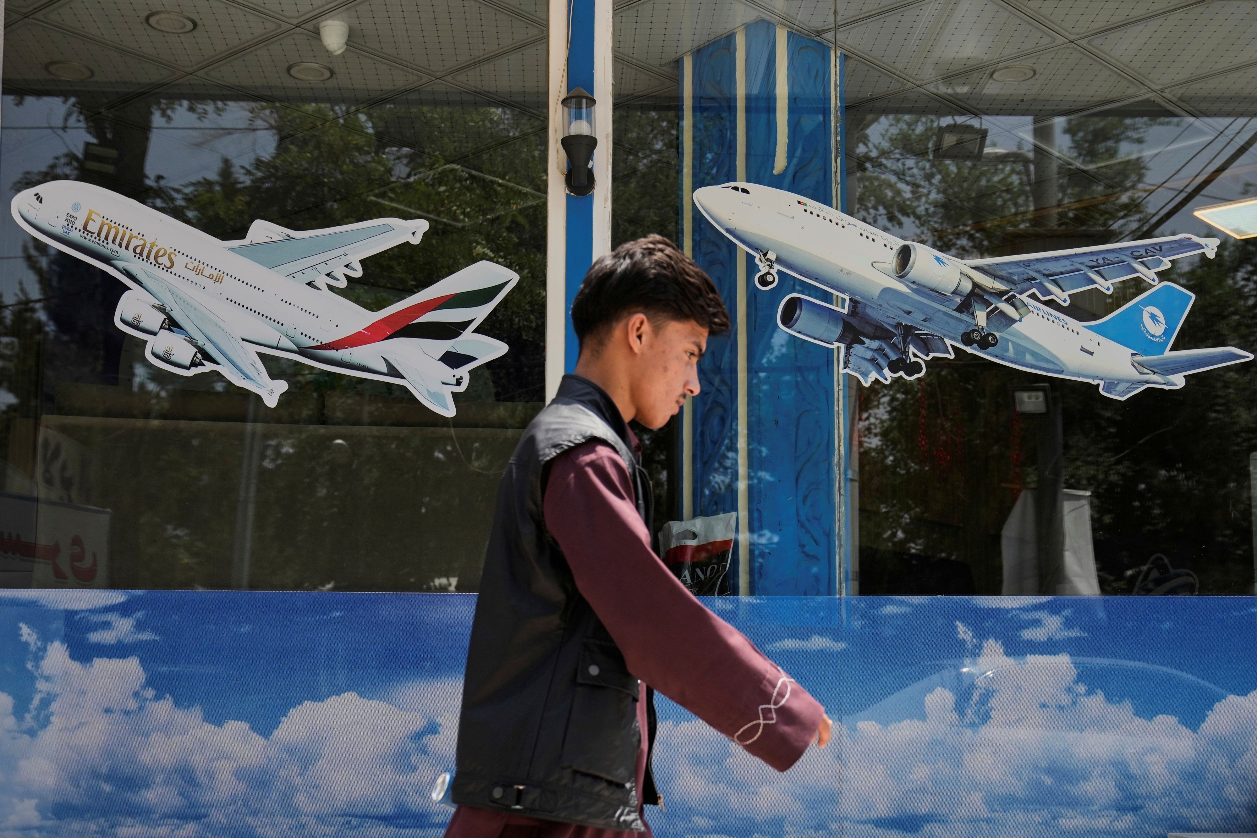 A man walks in front of an air travel agency in Kabul, Afghanistan