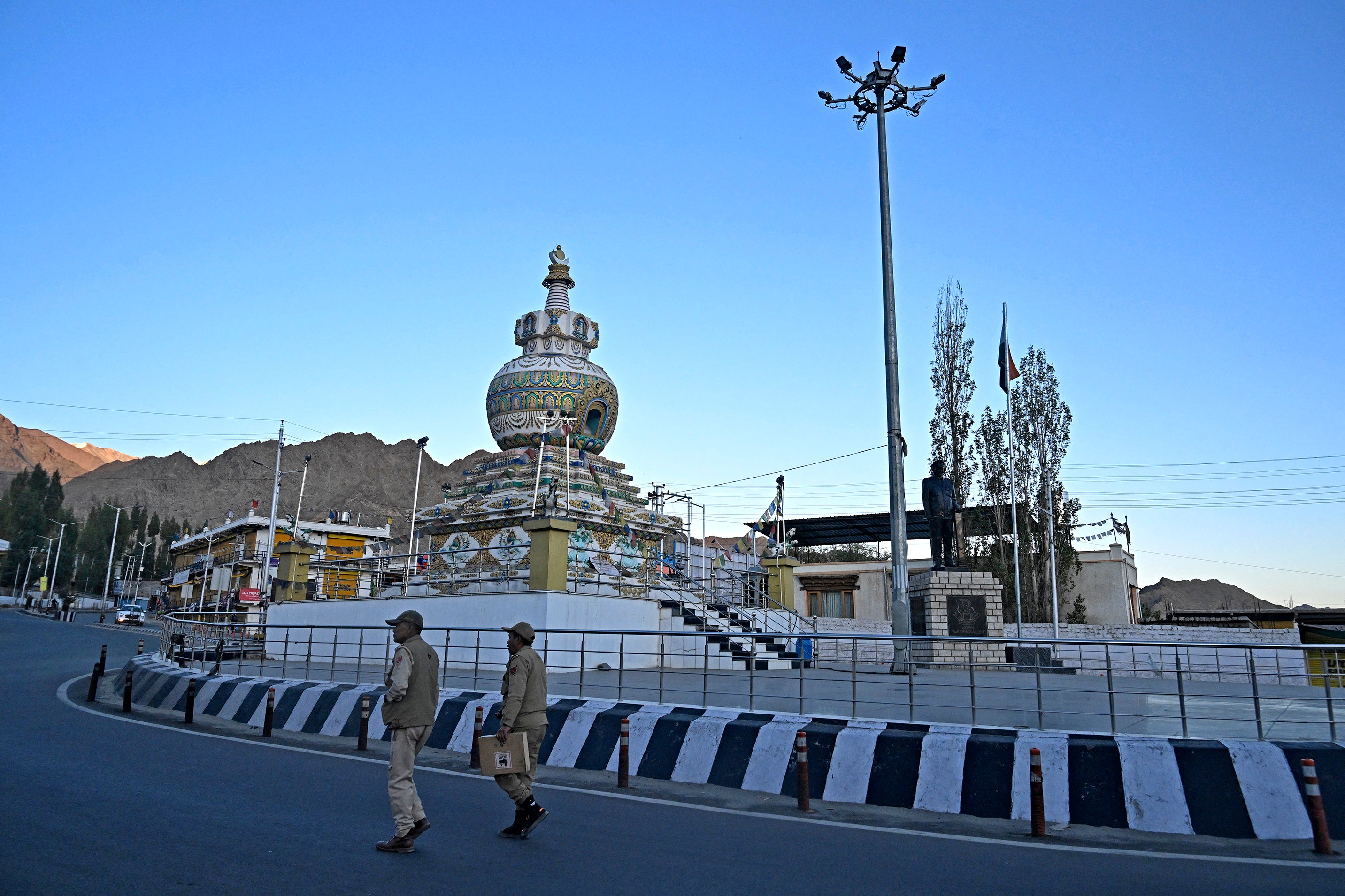 Indian policemen patrol a road in Leh on September 25, 2025. 