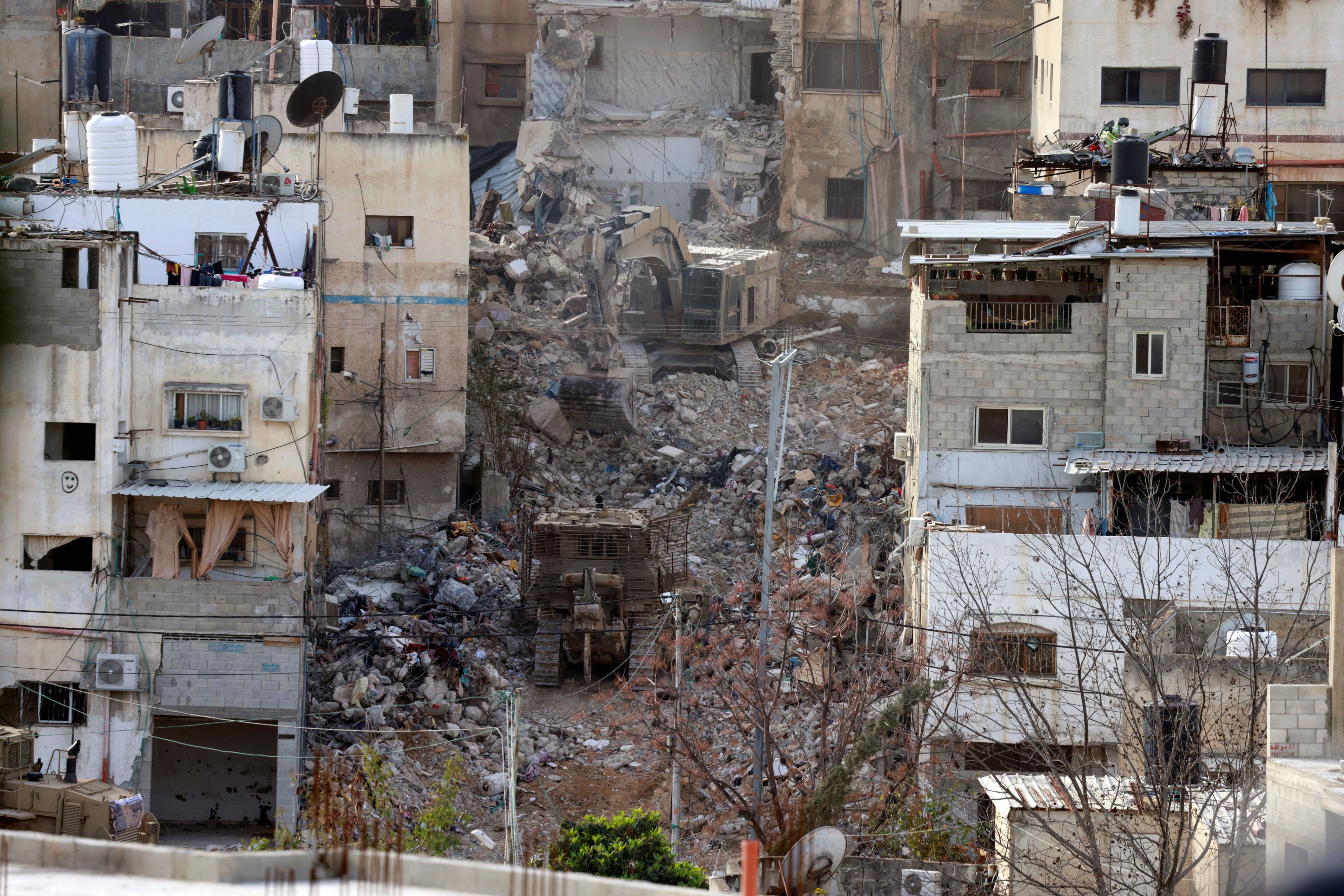 Israeli military excavators demolish buildings in Tulkarem refugee camp
