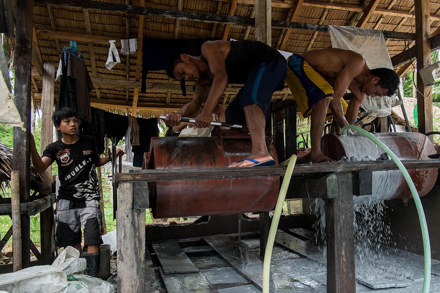 Mine workers operate ball mills