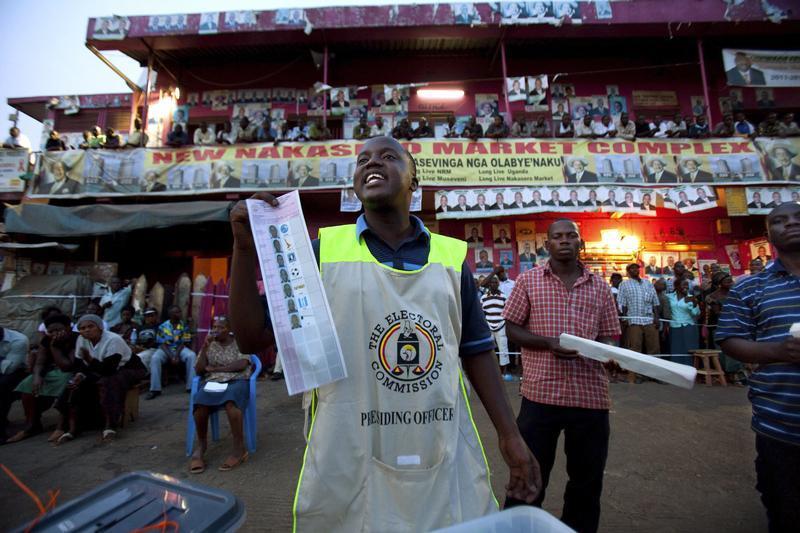 Ugandan poll workers count ballot papers at Nakasero Market polling station in Uganda’s capital Kampala on February 18, 2011. 