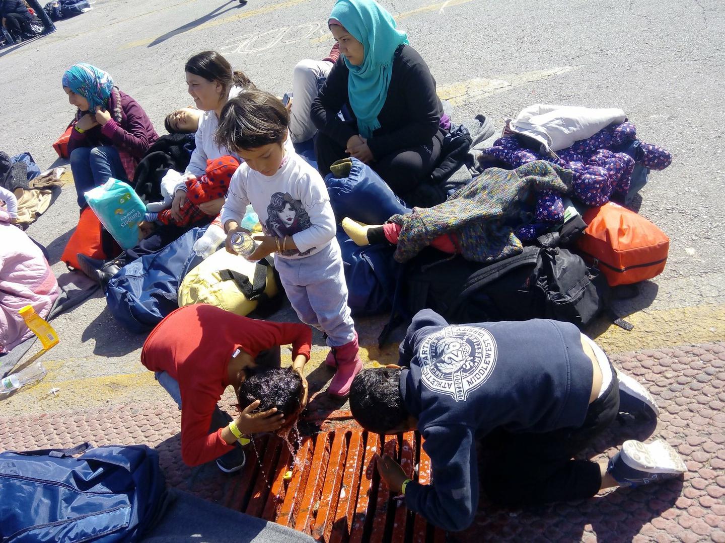 Children washing outside a makeshift camp for asylum seekers and migrants at the port of Piraeus, in Athens. The UN refugee agency, UNHCR, estimates that women and children now make up nearly 60 per cent of those seeking refuge in Europe.