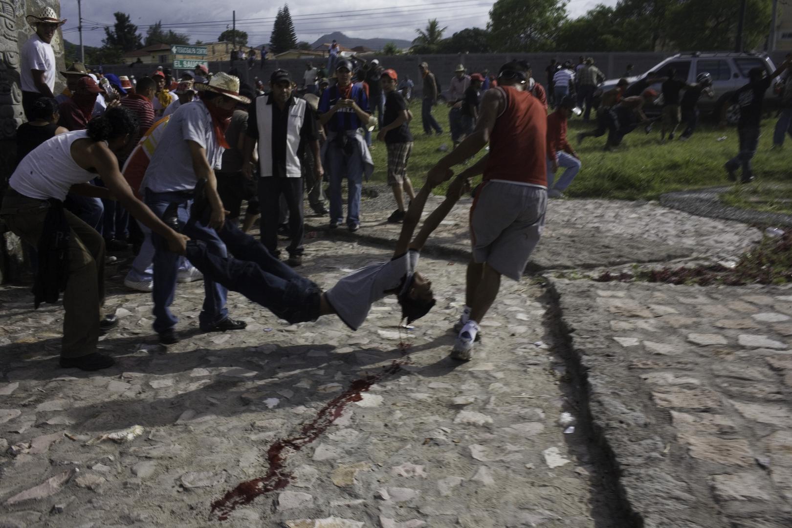 Teenager Isy Obed Murillo, who died from a gunshot to the head, is being carried off by demonstrators.