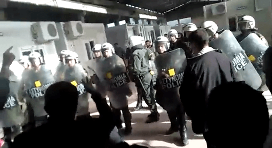 A still from video shows Greek police at the VIAL detention center on Chios as deportees protest their pending return to Turkey on April 3, 2016.