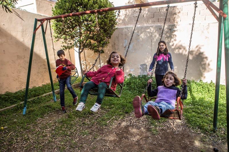 Rudi, Lava, Elin and Evin play in the backyard of the apartment in which they were staying in Aigaleo. © 2017 Anna Pantelia