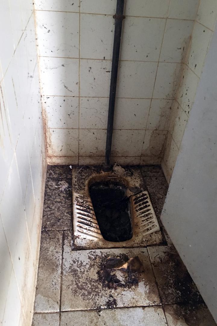 Un baño de la escuela secundaria, donde no hay agua corriente.