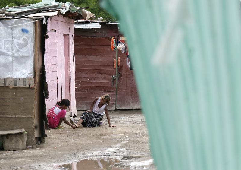 Roma children play in the Cesmin Lug Camp outside Trepca mine, on the outskirts of Mitrovica, June 22, 2009.