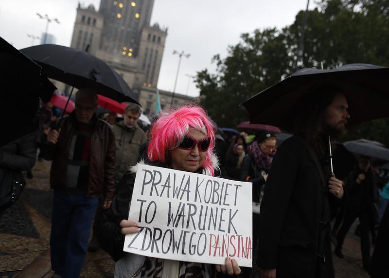 A woman takes part in a rally marking the first anniversary of the “Black Protest” against plans of changing the abortion law, in front of Palace of Culture and Science in Warsaw, Poland October 3, 2017. The poster reads "Women's rights are a condition of