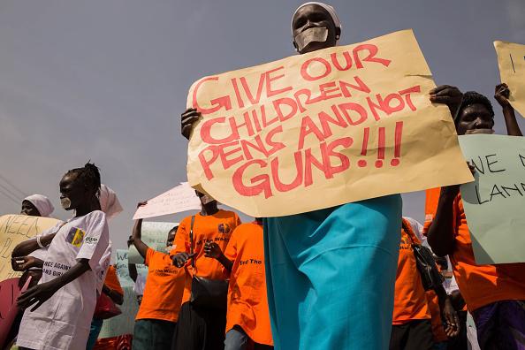Women from more than forty South Sudanese womens organizations carry placards during march through the city to express the frustration and suffering that women and children face in Juba, South Sudan on December 9, 2017.  