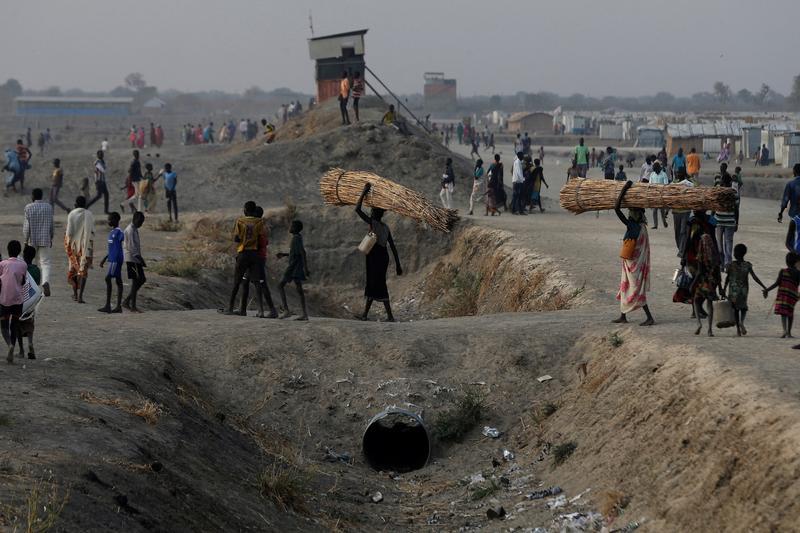 People walk inside the United Nations Mission in South Sudan (UNMISS) Protection of Civilians site (PoC), near Bentiu, northern South Sudan, February 9, 2017. 