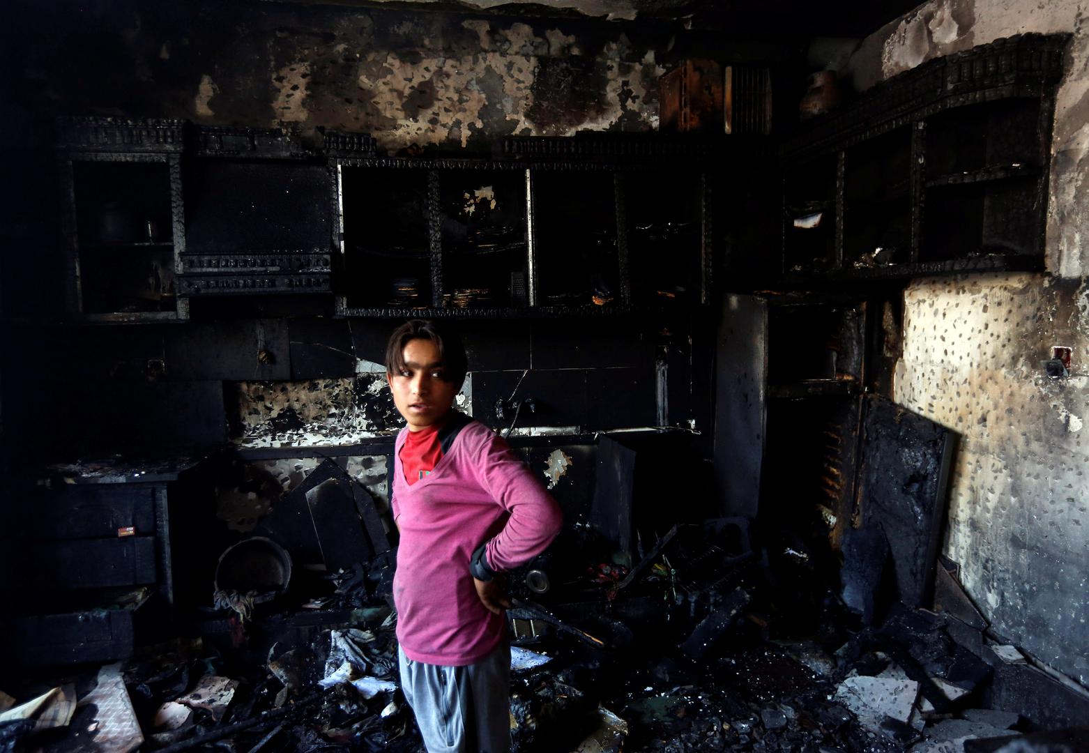 An Afghan shopkeeper inspects his shop after the suicide attack in Kabul on July 24, 2017.