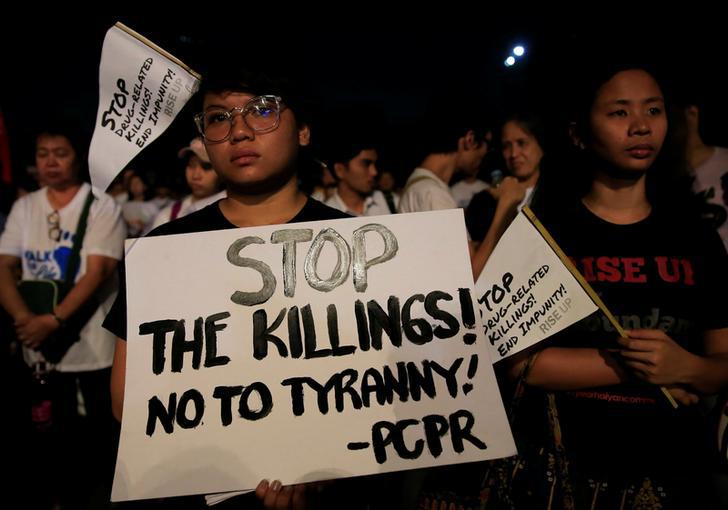 Participants display placards as they participate in a procession against plans to reimpose death penalty and intensify drug war during "Walk for Life" in Luneta park, Metro Manila, Philippines February 24, 2018. 