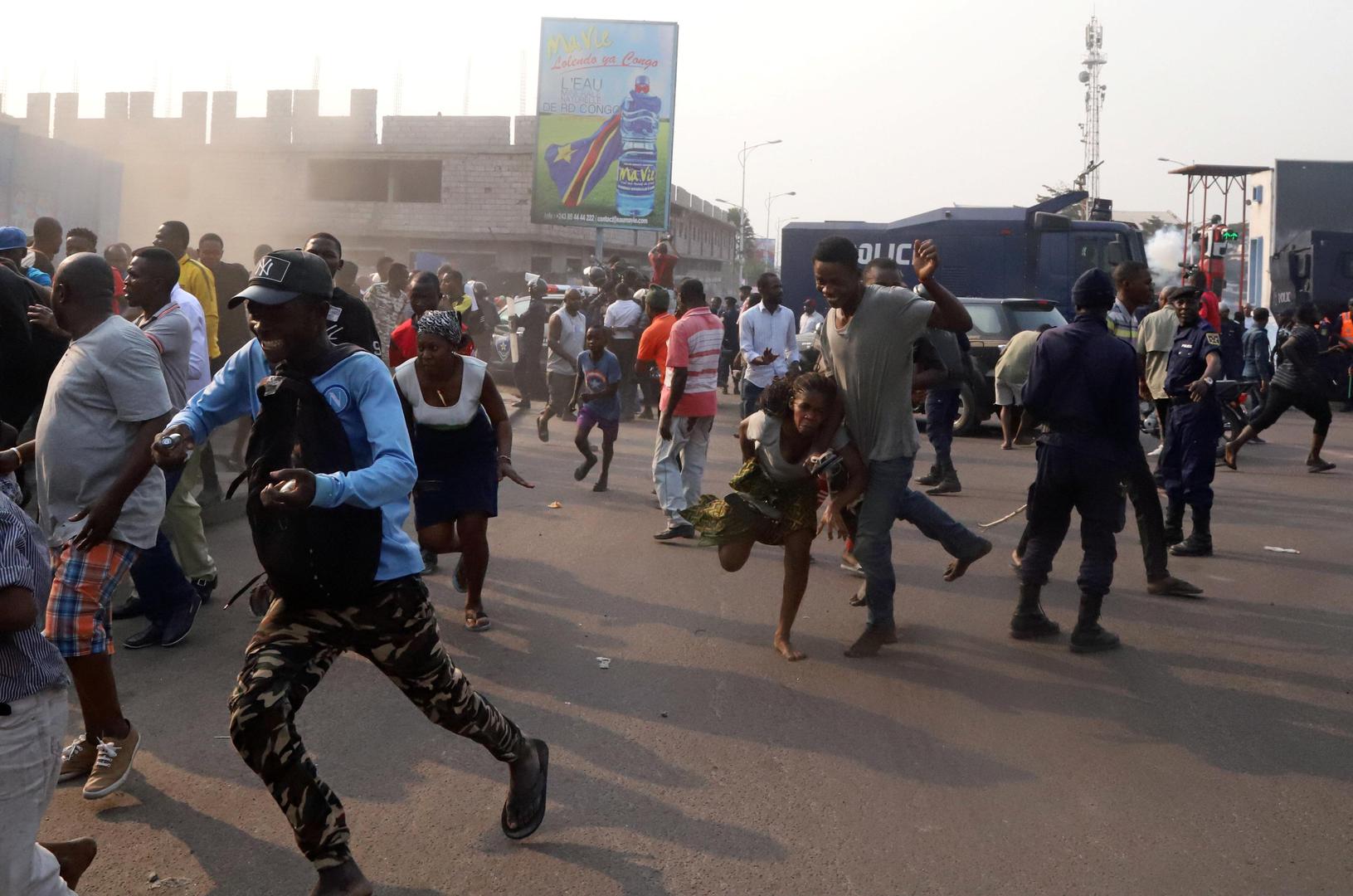 Supporters of Congolese opposition leader Jean-Pierre Bemba run to take cover after riot police fired teargas to disperse them in downtown Kinshasa, Democratic Republic of Congo, August 1, 2018.