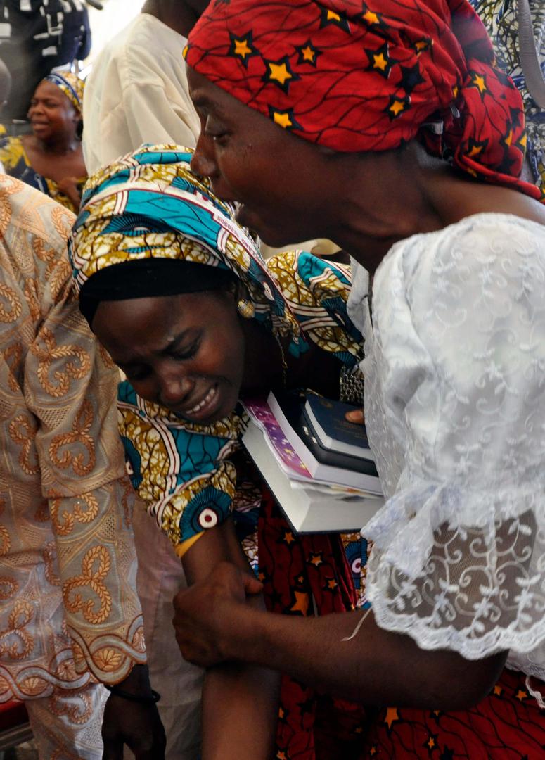 One of the kidnapped Chibok girls celebrates with a family member following her release in Abuja, Nigeria, Sunday, Oct. 16, 2016.