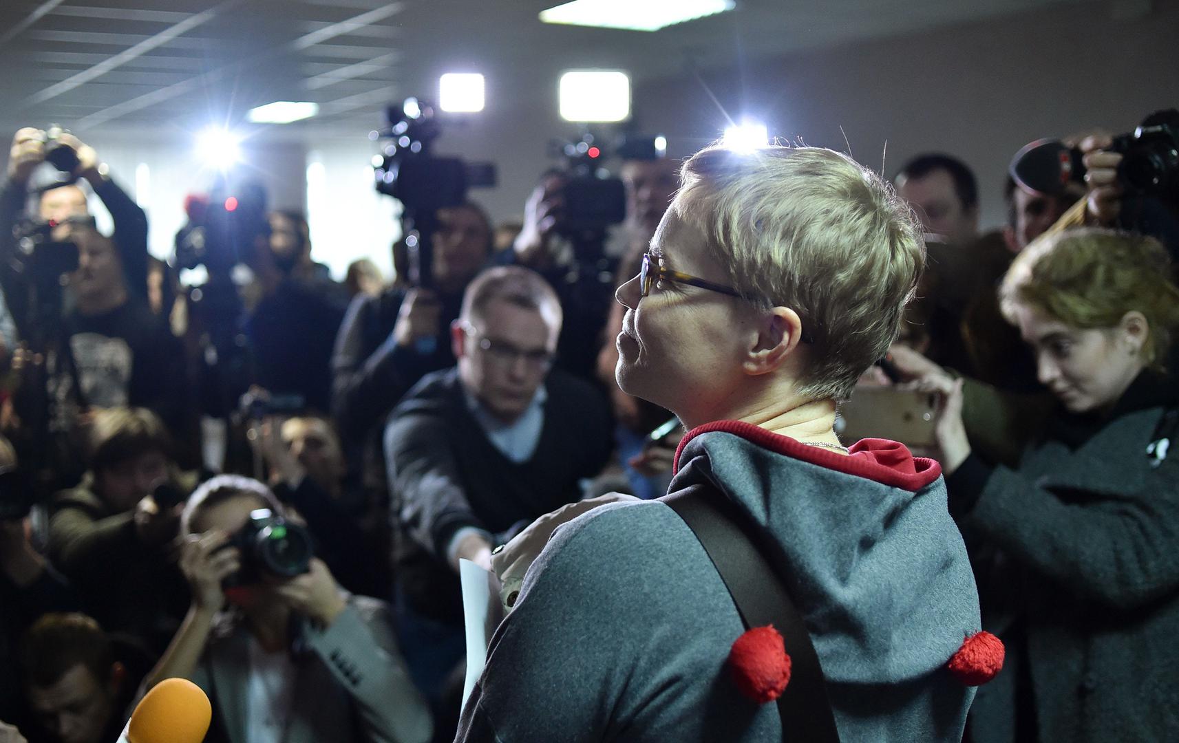 The media photograph Marina Zolotova, editor-in-chief of news portal tut.by, as she attends her trial for alleged 'unauthorised access' to information from state-run BelTA news agency, in Minsk, March 4, 2019. © 2019 SERGEI GAPON/AFP/Getty Images